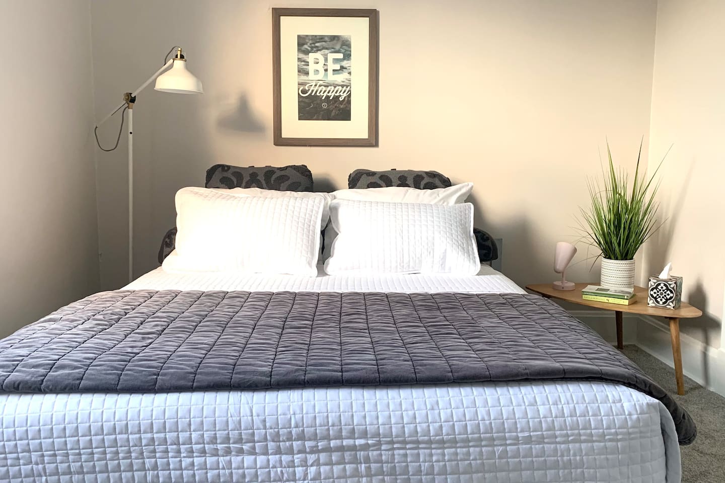 Queen Bedroom - calm, curated design for restful nights, featuring soft cotton linens, blackout shades, and personal fan.