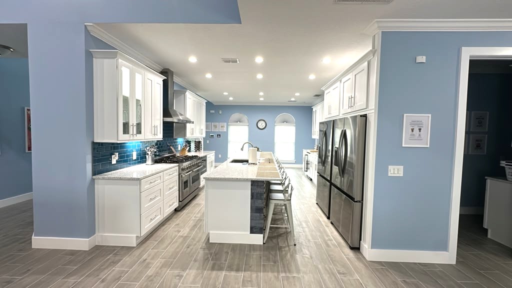 Chef Kitchen with huge island, range, two fridges, drinks fridge, and more. 