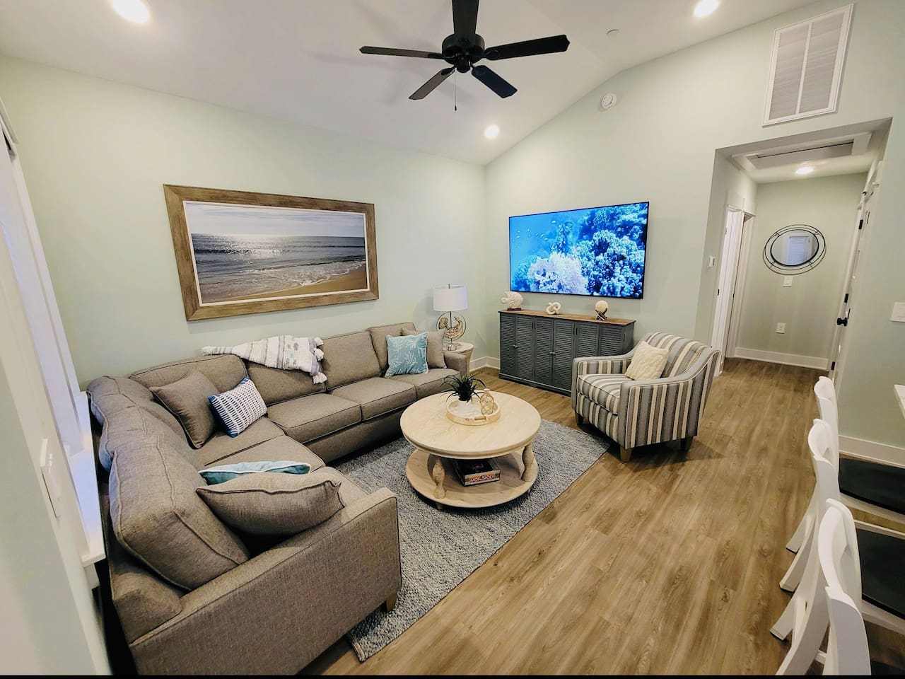 Large open living room with a 75 inch Smart TV.