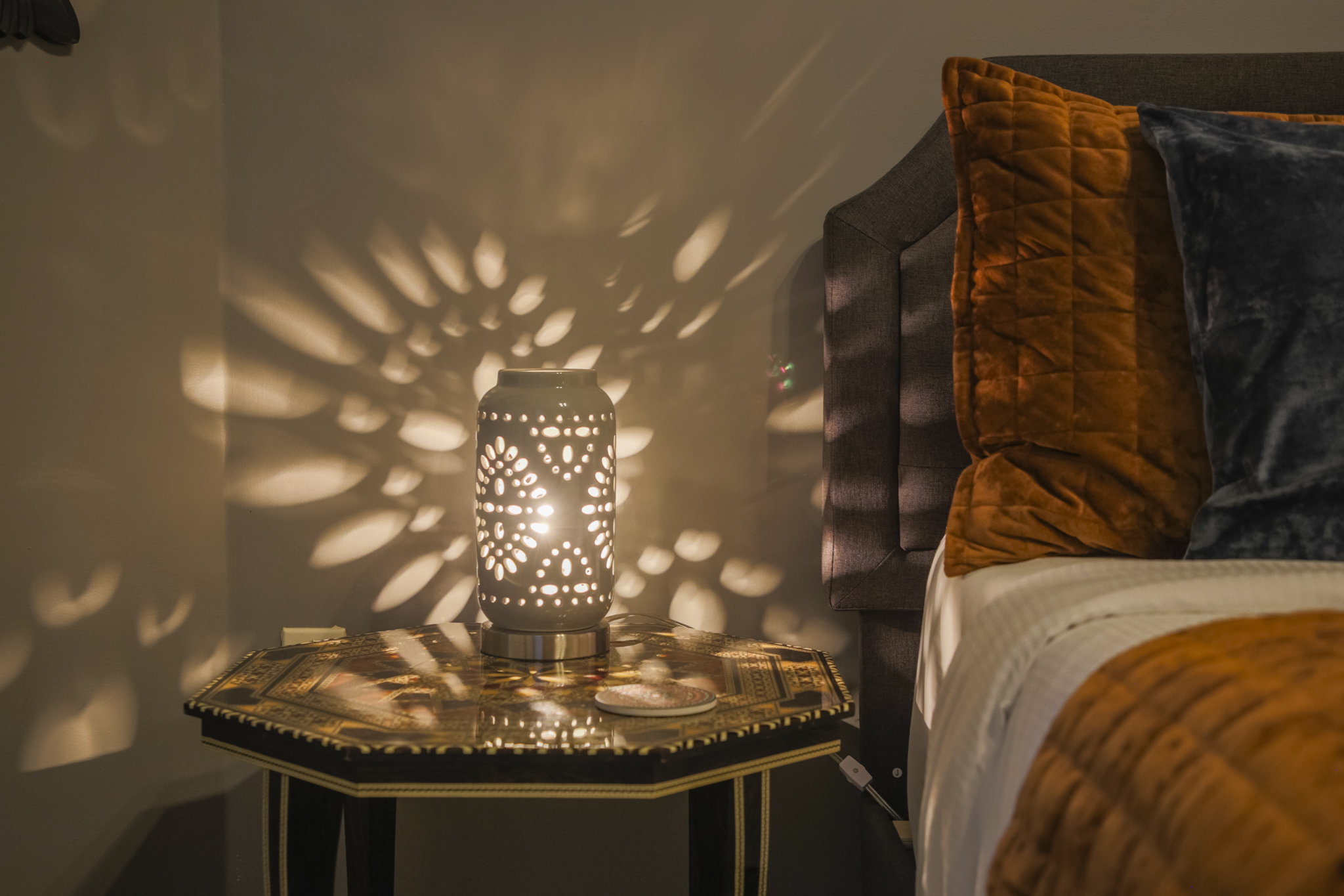 A distinctive lamp adds a touch of personality and charm to the king bedroom.