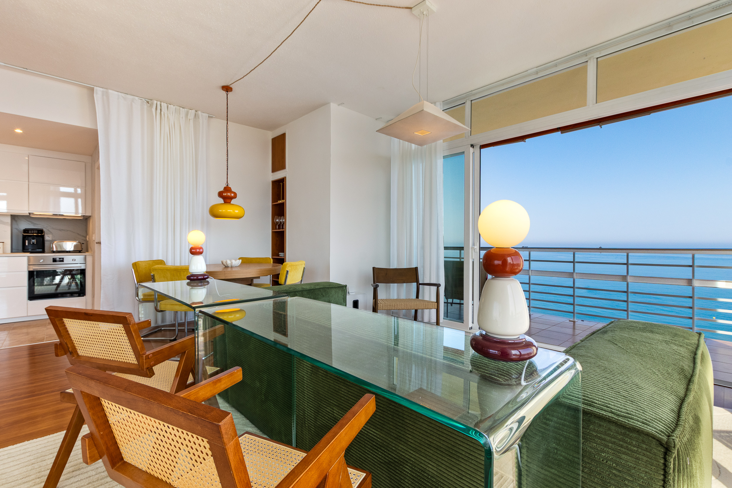 Open-plan lounge, dining area and kitchen with panoramic Mediterranean sea views.
