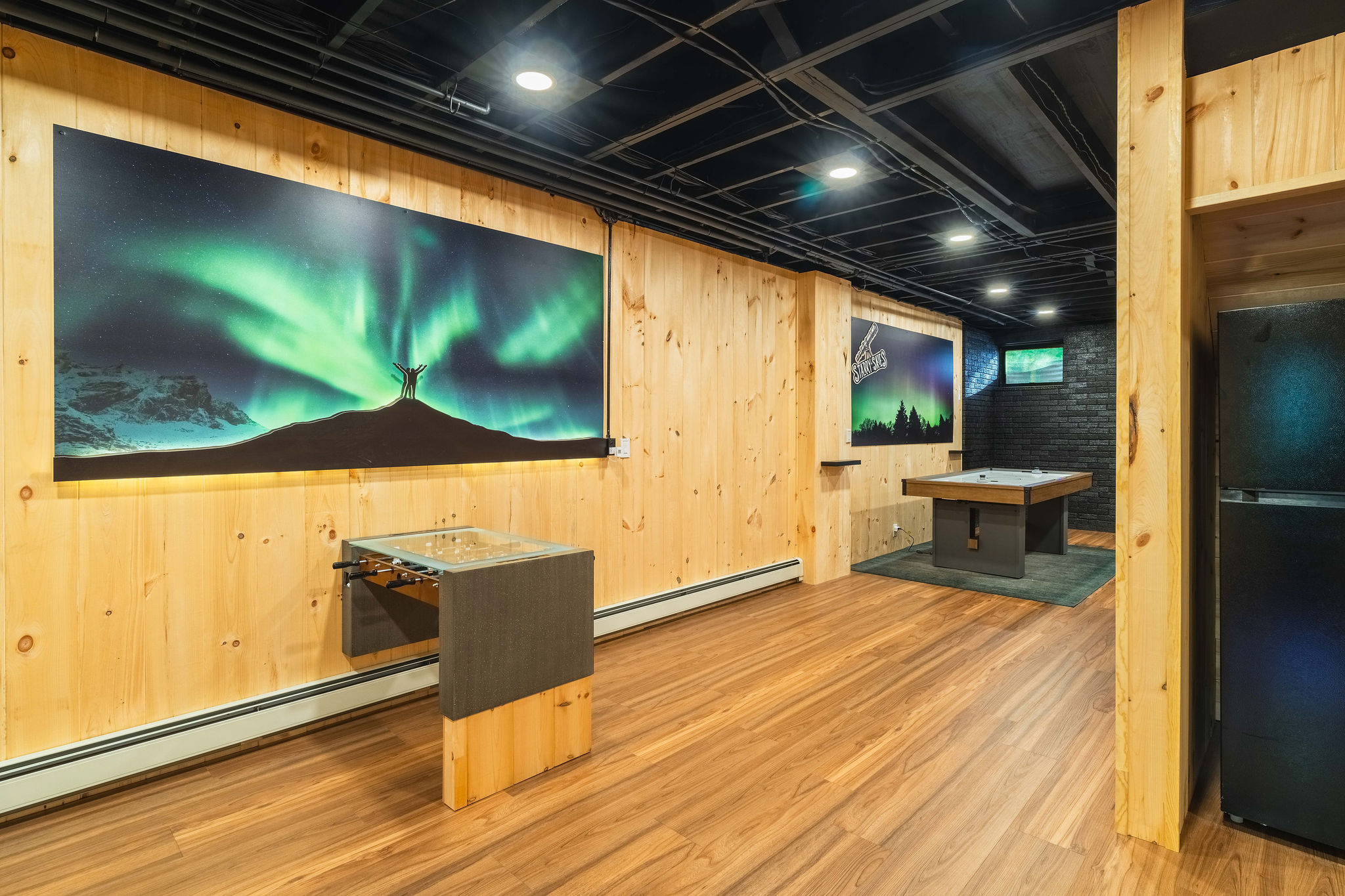 🌌 Northern Lights game lounge with foosball, air hockey and an extra fridge for cold storage.