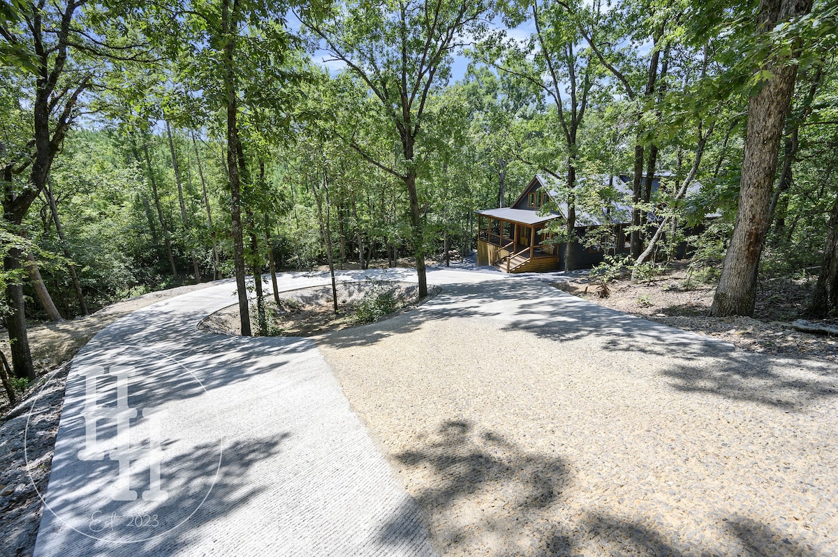 Our paved entrance and circle drive. Trees are illuminated at night.