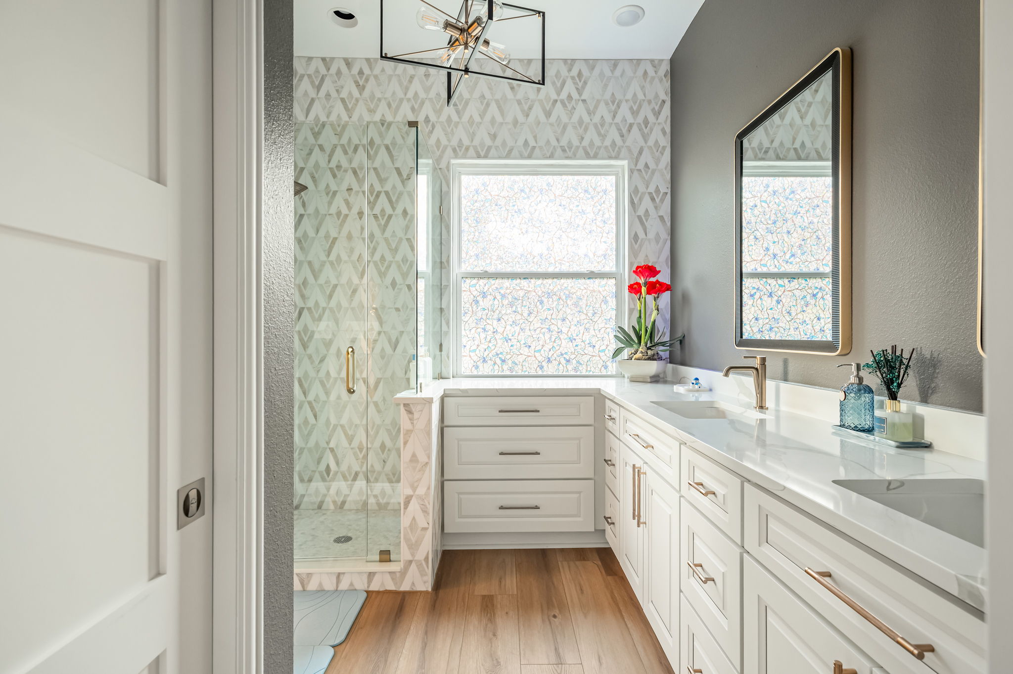 Bright double-vanity bathroom with elegant finishes and plenty of counter space.