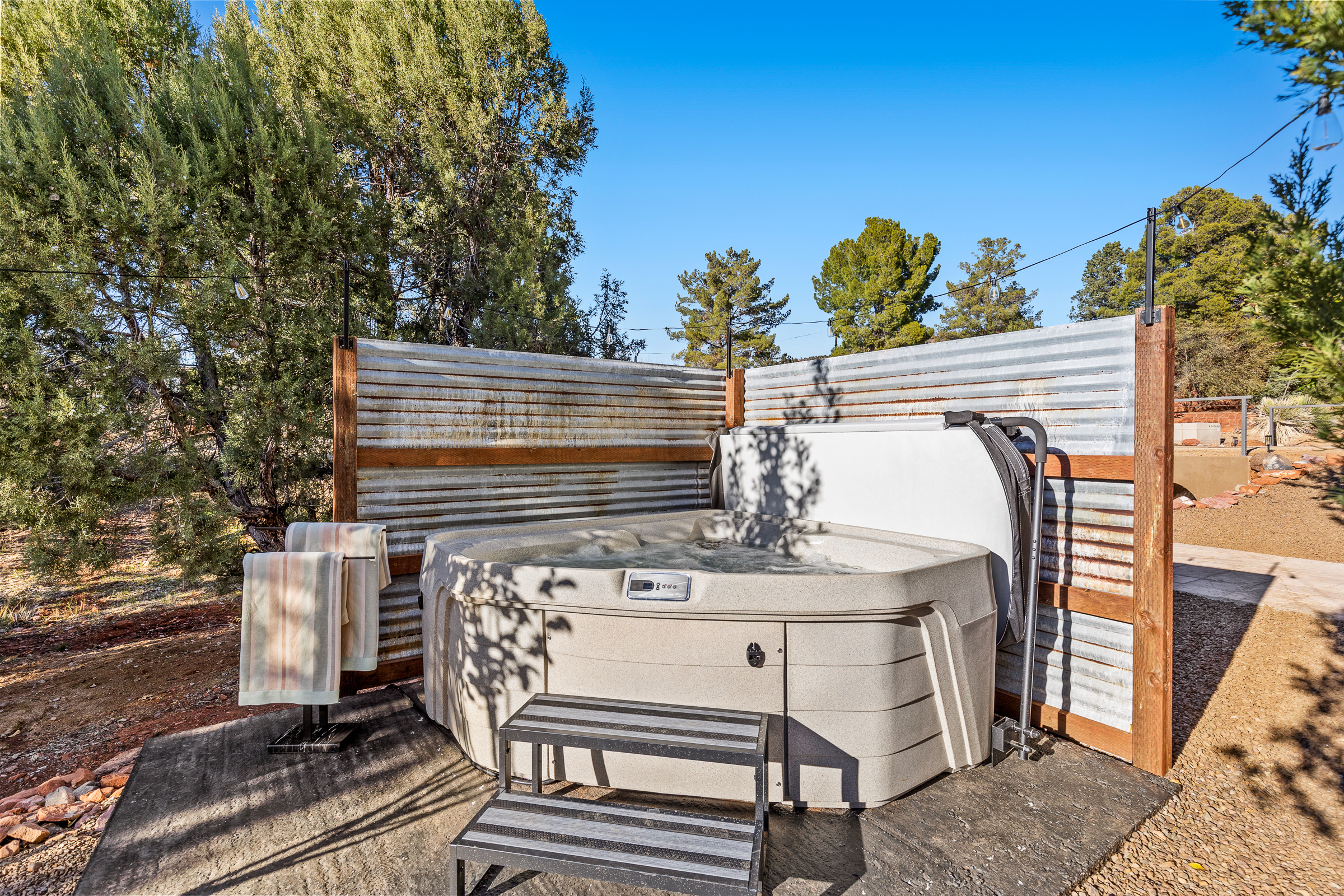 Private 2-person hot tub at the guesthouse, tucked behind privacy fencing and surrounded by Sedona’s peaceful desert landscape.