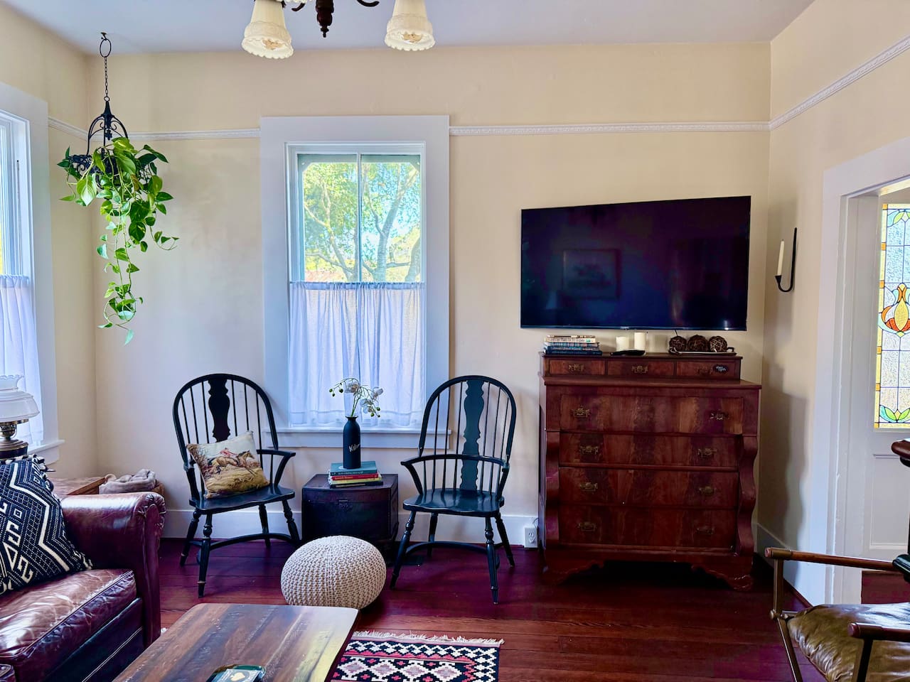 Old soul, modern comforts. The light-filled living room pairs antique furnishings with a Smart TV on a movable arm, so every seat works. Games and cards are tucked into the dresser for evenings when everyone is ready to unplug.