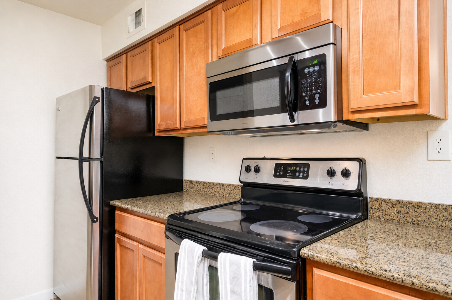 Kitchen with stove, microwave, refrigerator, and storage for short or extended stays.