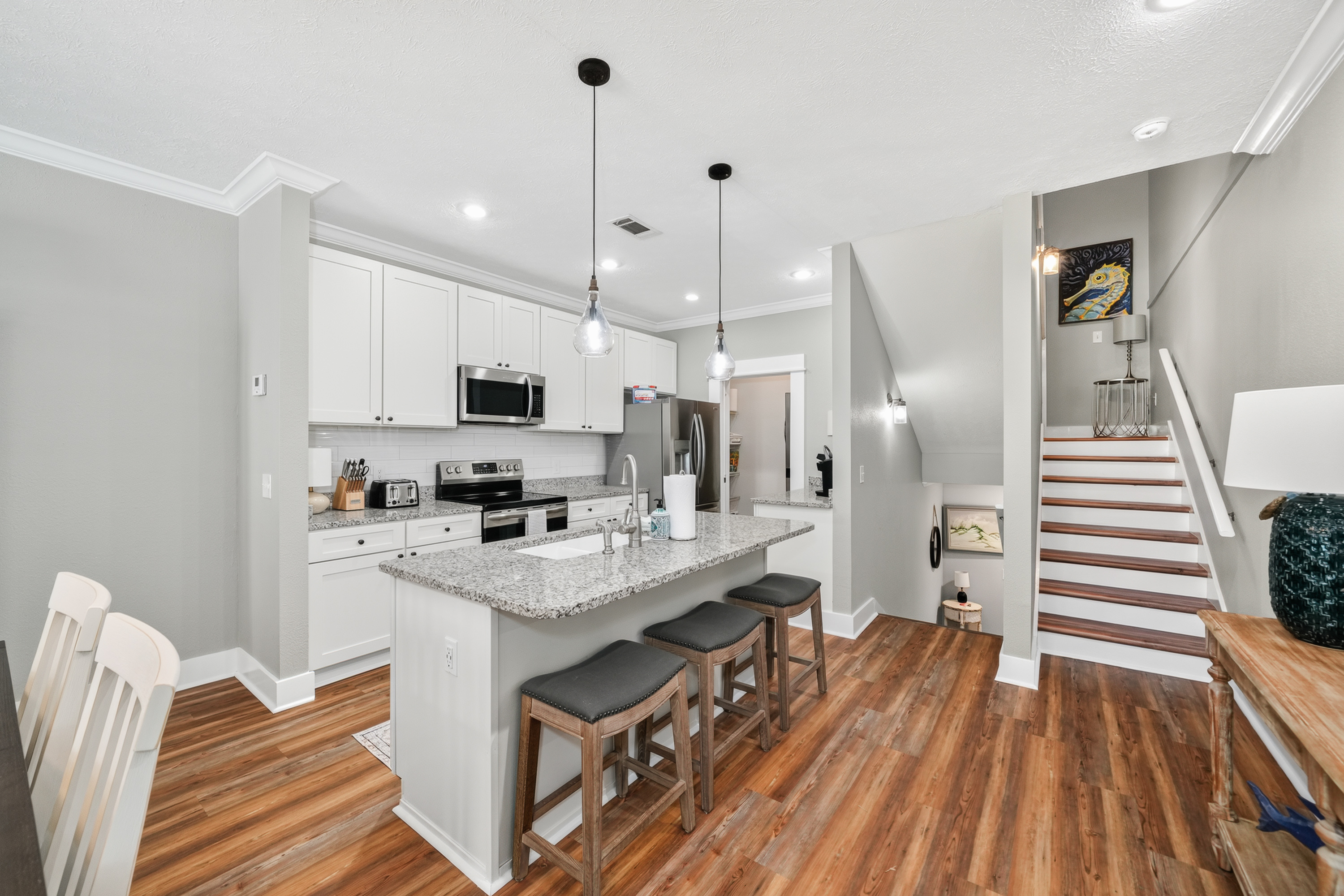 Bright gourmet-style kitchen featuring a spacious island, modern appliances, and generous counter space