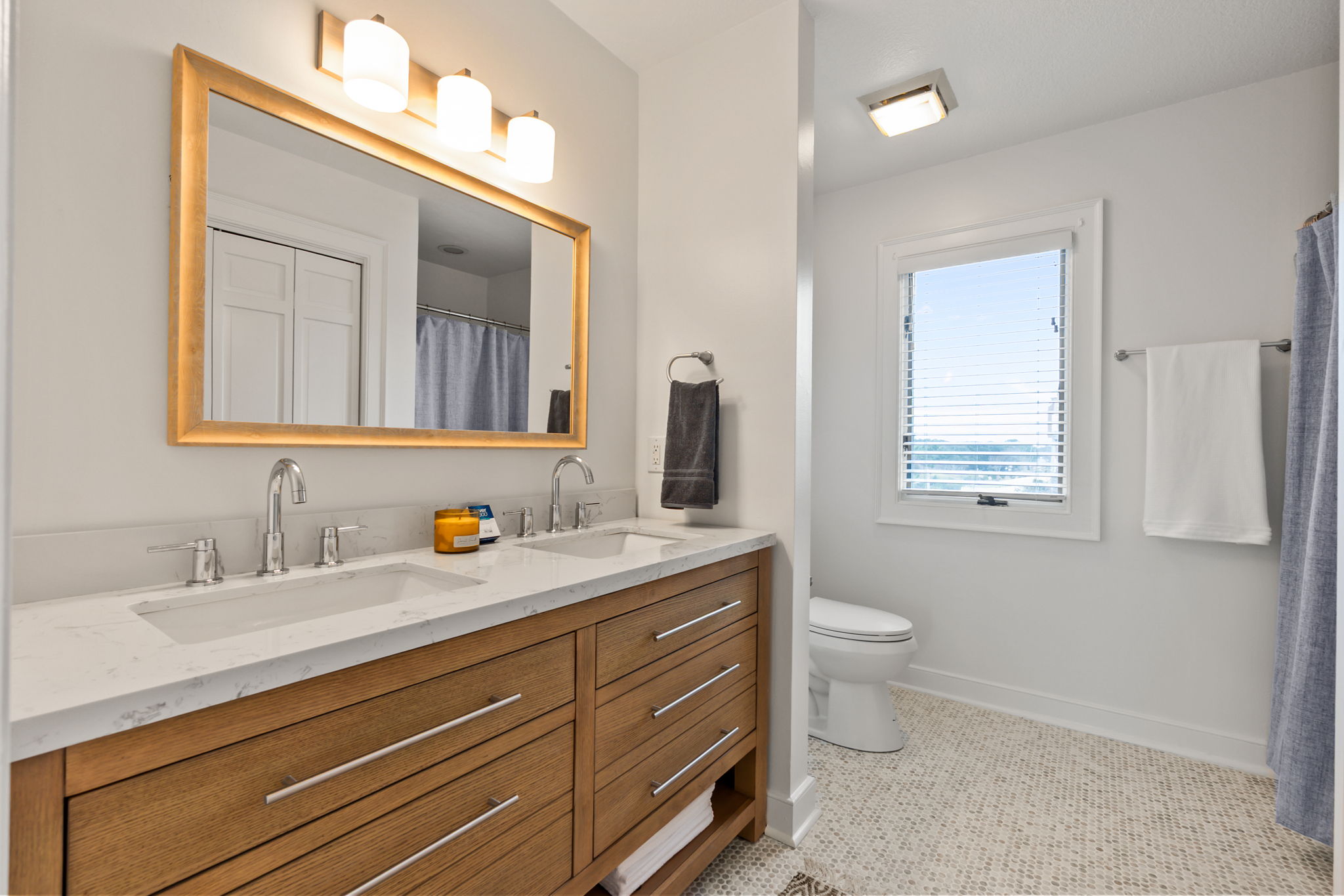 King br #2 Ensuite Bathroom with double sinks and a large mirror, plus a separate toilet/shower area.