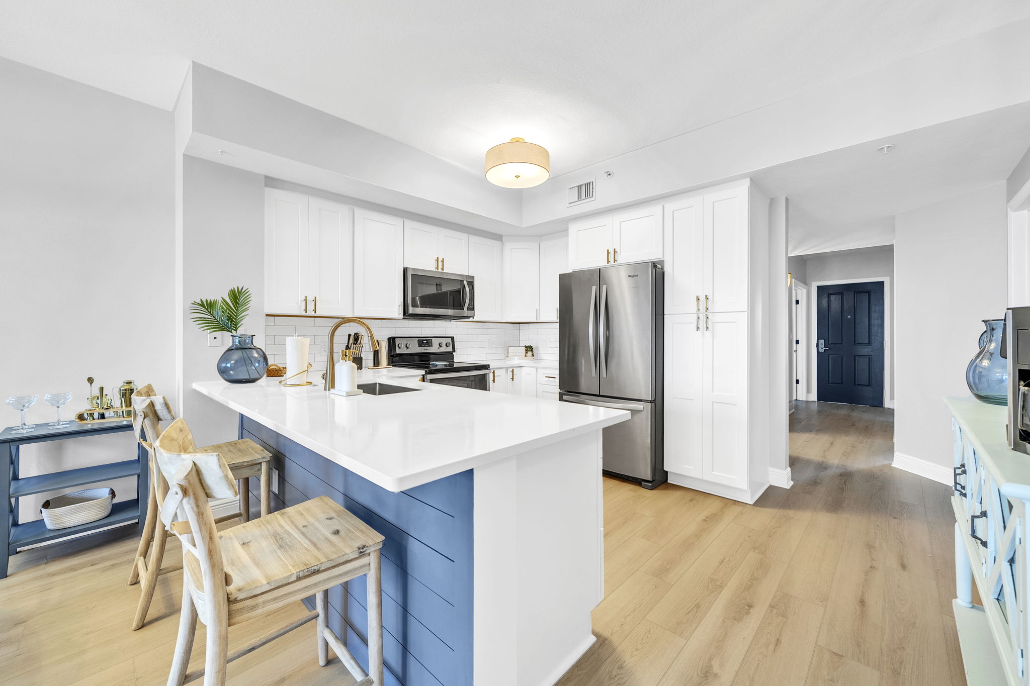 Cook, gather, and connect in this bright, fully equipped kitchen featuring modern appliances, spacious countertops, and bar seating—perfect for everything from quick breakfasts to family meals.