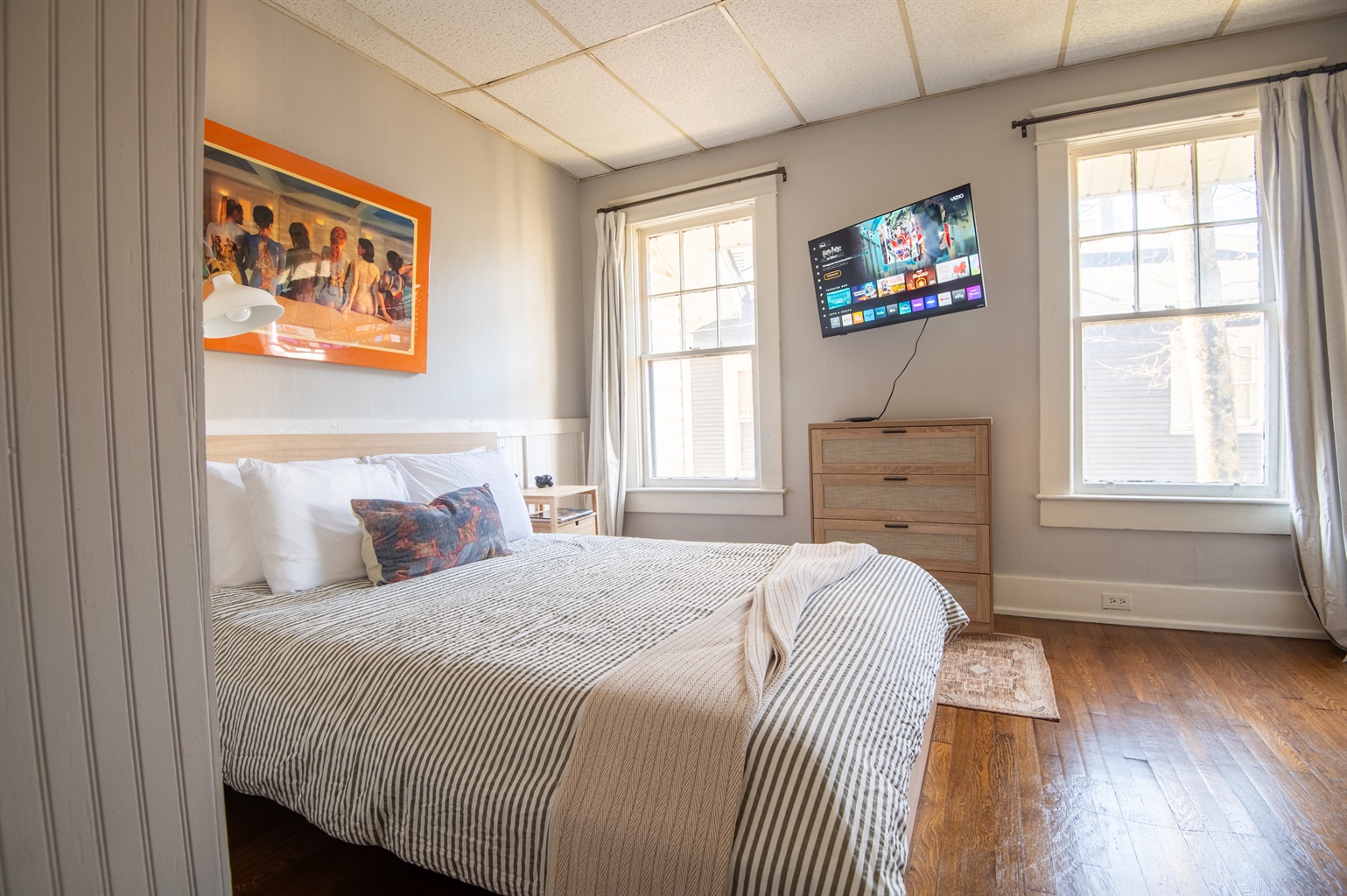 Cozy bedroom with queen bed, crisp linens, and ample natural light.