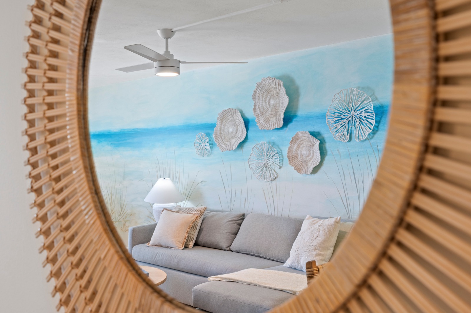 Relax into coastal calm on the sectional, surrounded by ocean-inspired art and soft textures for a true seaside escape.
