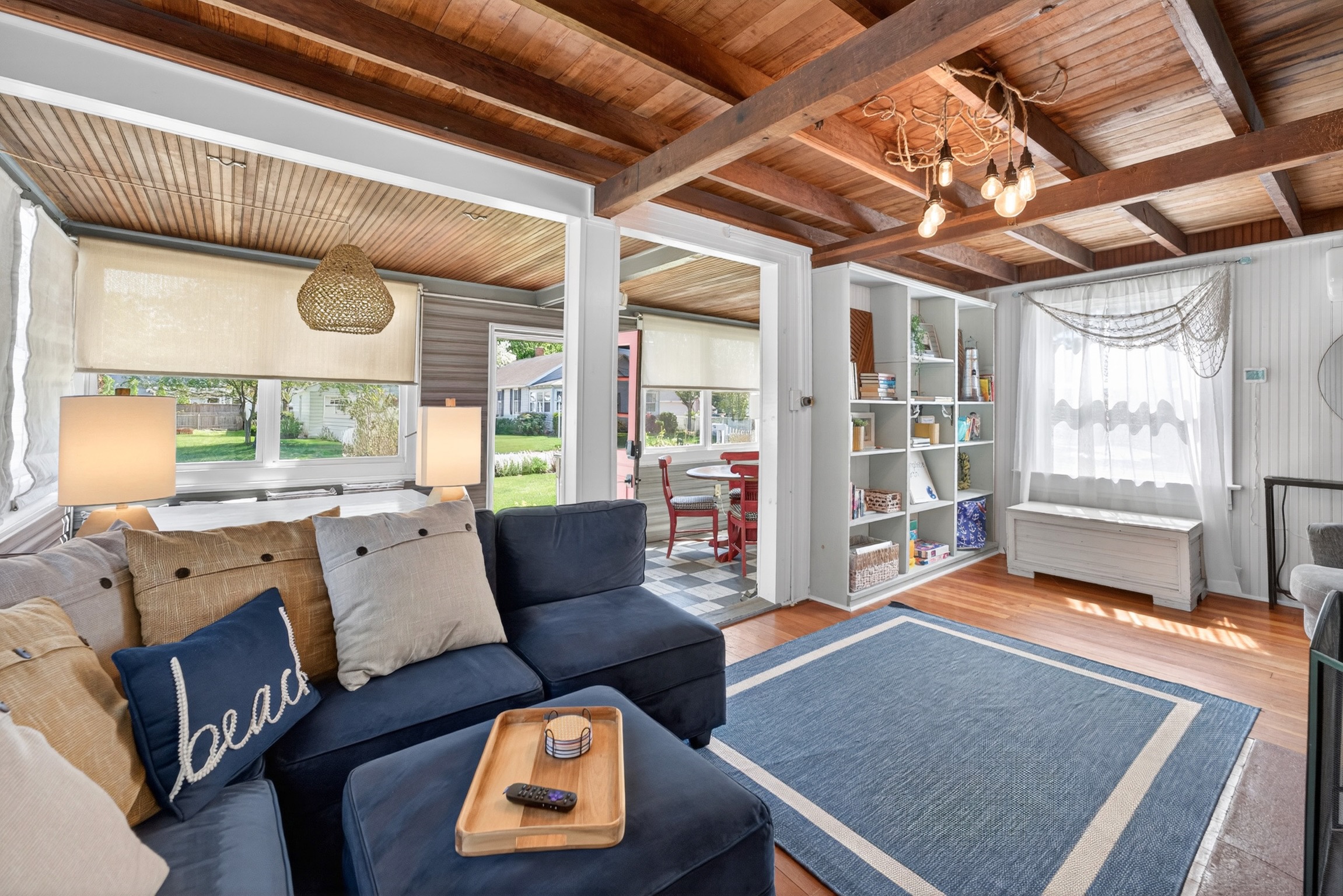 Comfortable living room featuring an abundance of games, books, cozy seating, and a smart TV for relaxing nights in.