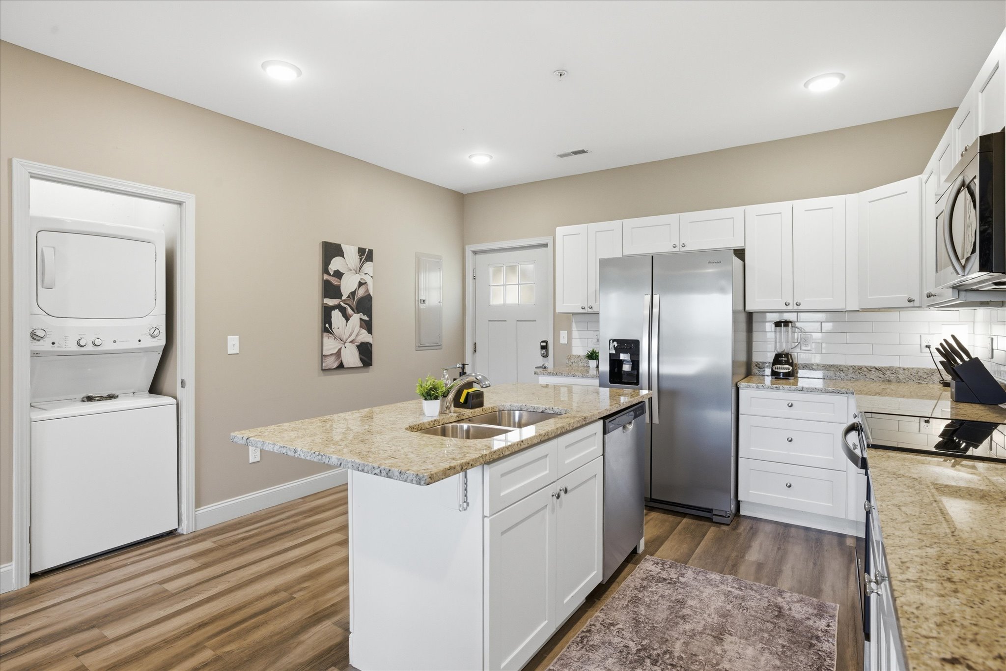 Unit 1 makes longer stays easier—this in-kitchen laundry setup lets you throw in a load and keep your day moving without having to step away or think twice.