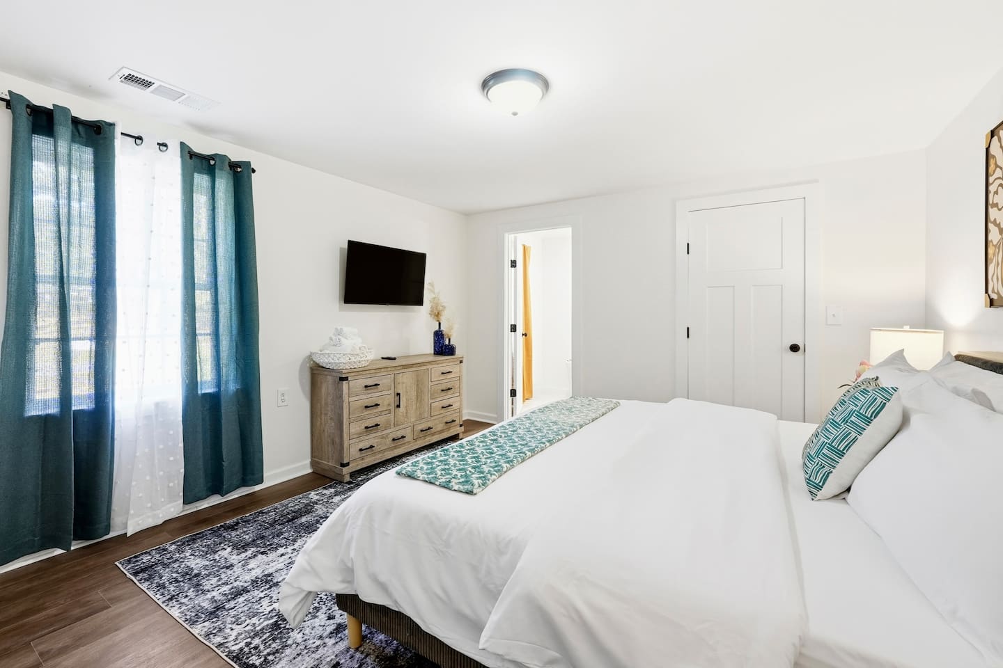 Finally, the basement bedroom features a beautiful, cool-toned color scheme with natural accents, a king bed, and a Roku-powered Smart TV. This room includes 2 full-body towels, 2 washcloths, and 2 hand towels for your stay.