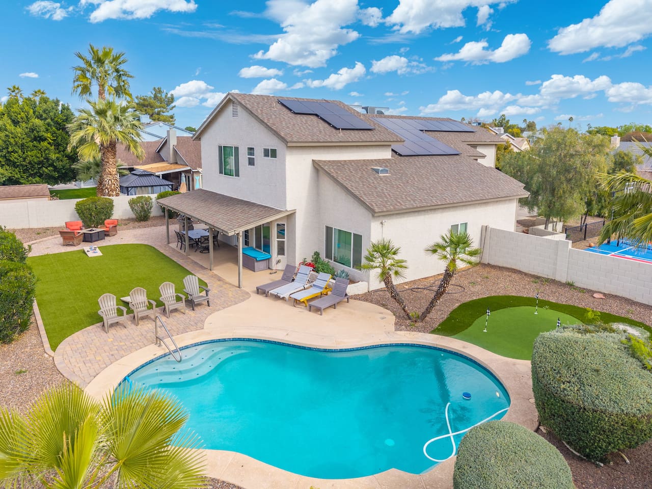 Stunning desert home with resort-style pool, solar panels, and manicured grounds perfect for groups.