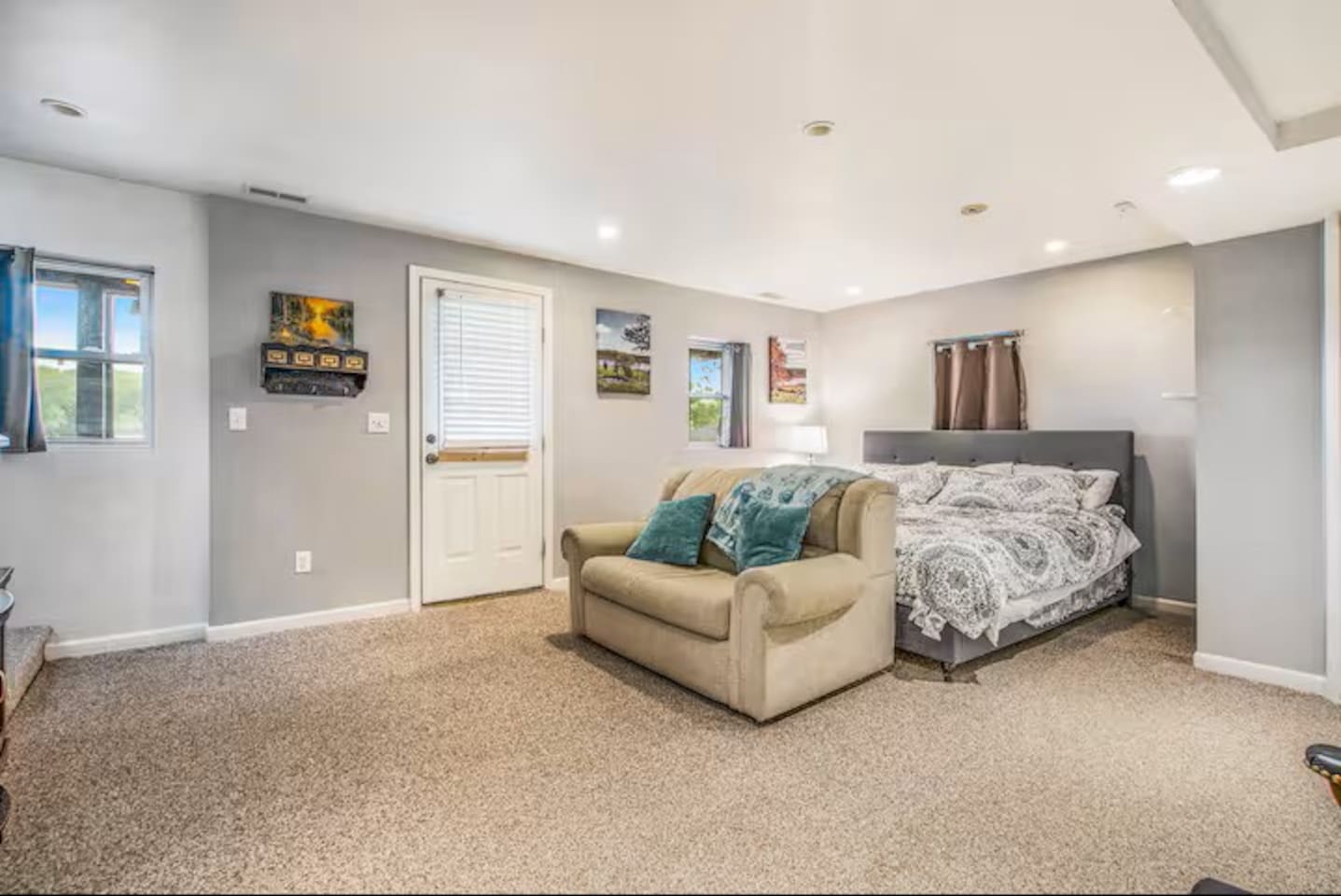 This bedroom is on the bottom level and also has an entrance to the back yard that faces the lake.  This area is a shared space if one is to use the sofa to sleep on as well. There is laundry and a full bathroom off this area. A crib is available