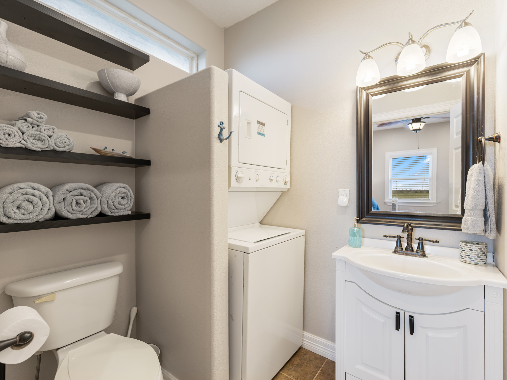 Primary bathroom with washer and dryer.