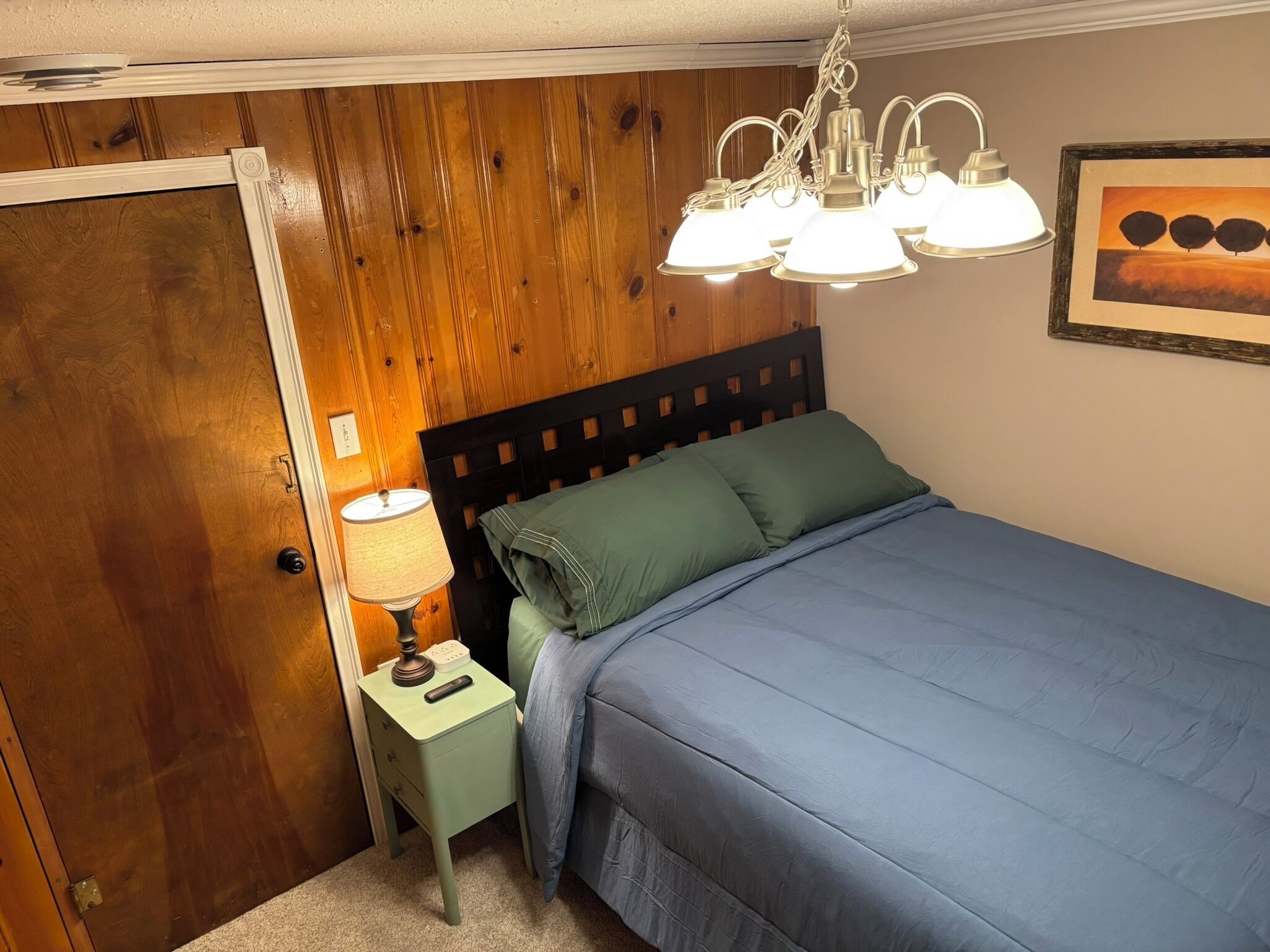Super comfortable queen bed, lamp and convenient charging ports.