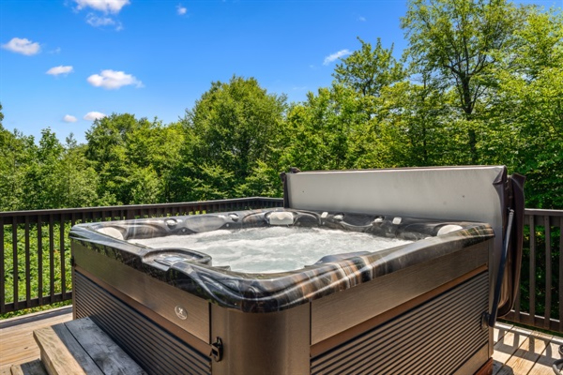 Unwind in the bubbling hot tub surrounded by lush mountain views and crisp mountain air for the ultimate reset.