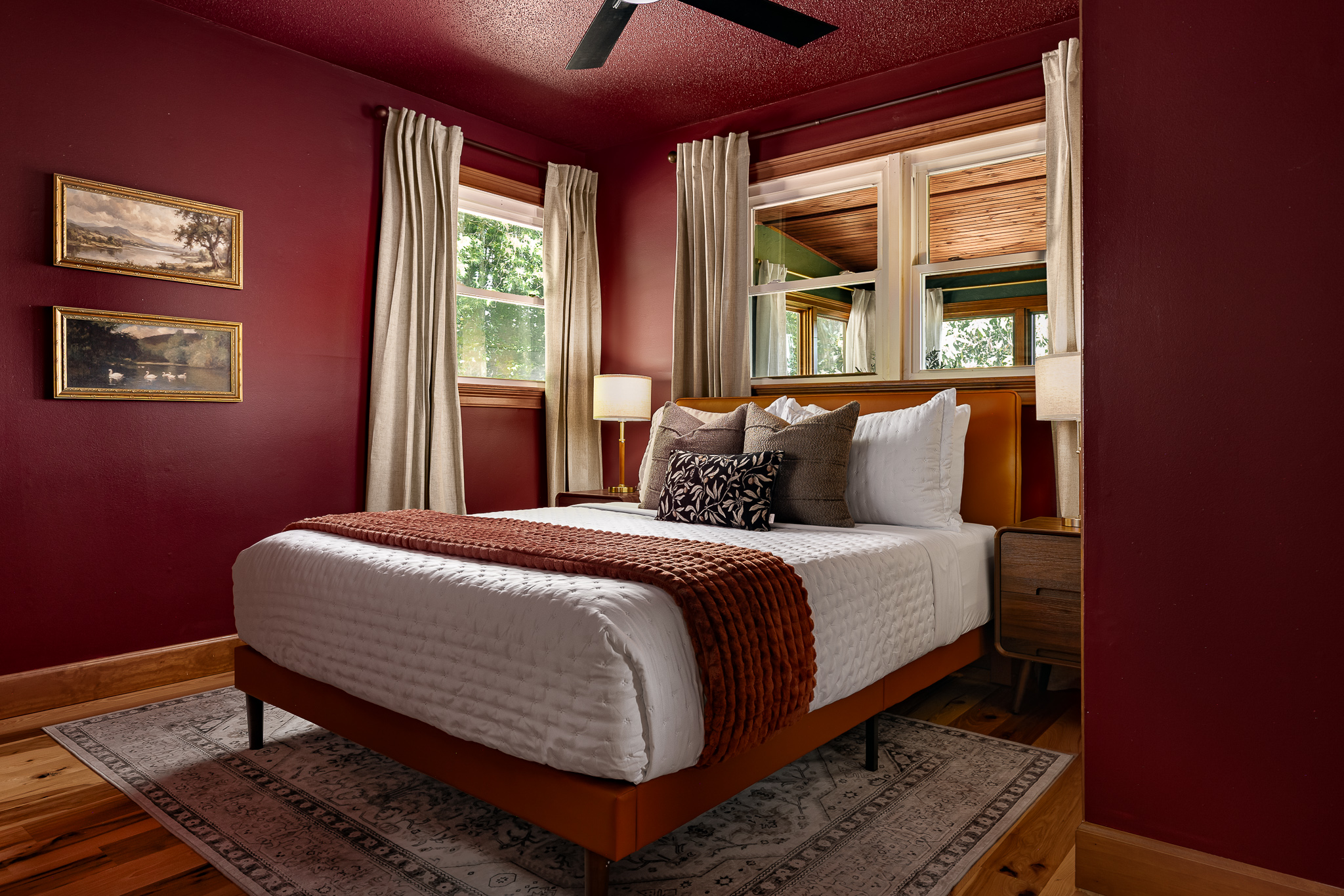 {Bedroom 4} Rich red walls and warm wood tones give this queen bedroom a cozy, distinctive mountain-retreat feel.