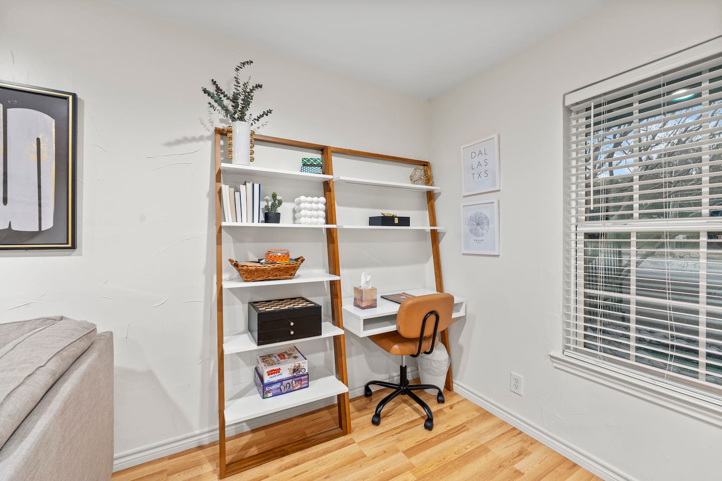 Stylish desk setup with shelving and natural light — ideal for getting work done while away from home.