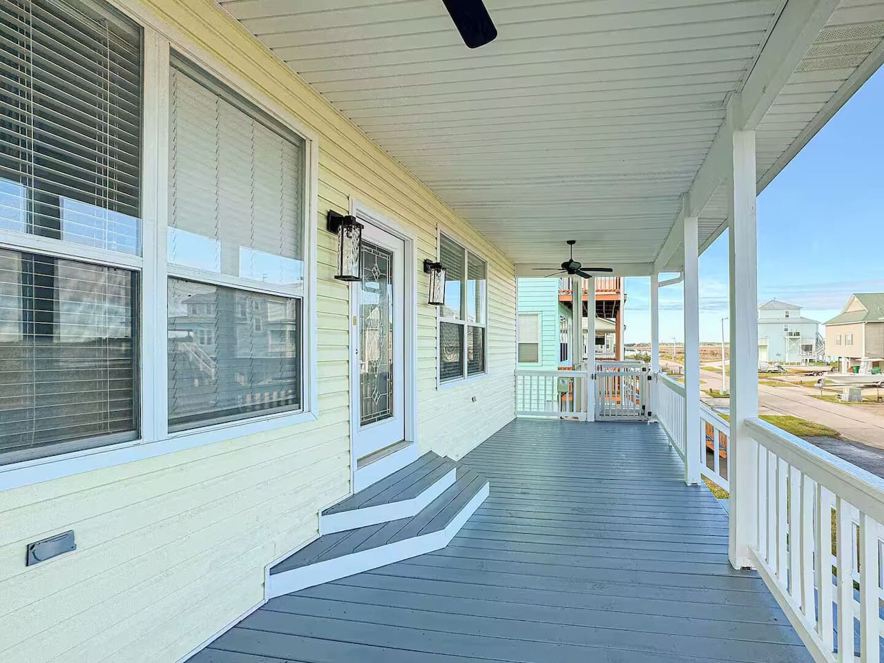 Spacious covered porch with ceiling fans and comfortable space to relax, enjoy fresh air, and unwind outdoors