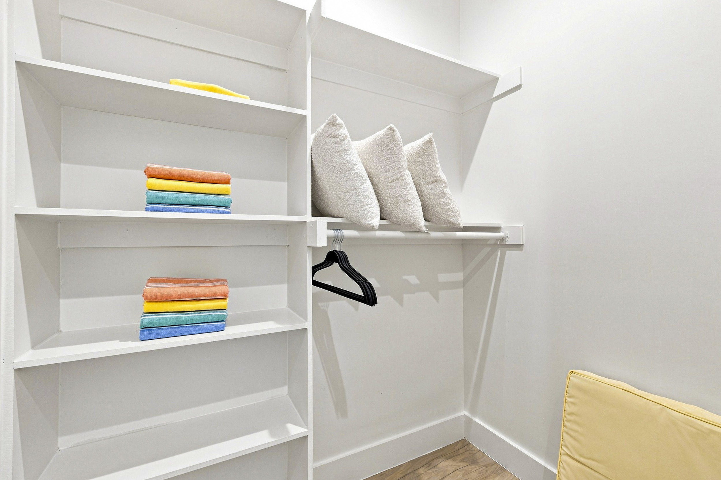 Bright and tidy space with colorful towels and plush pillows for ultimate convenience!