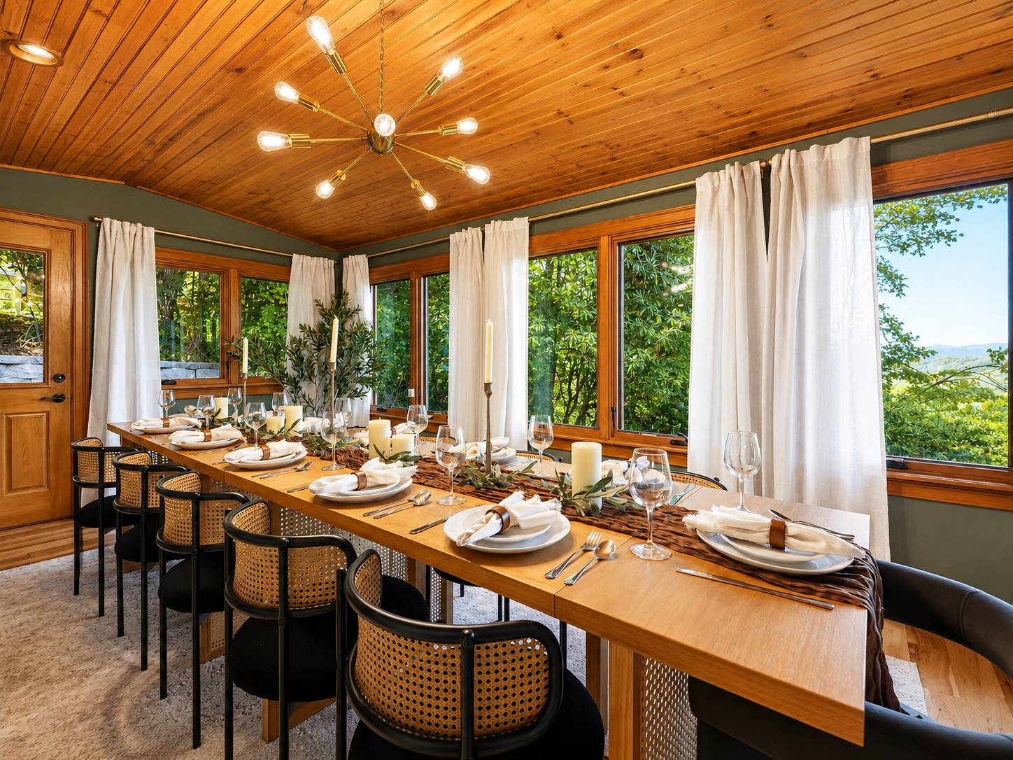{Dining Room} Gather around the oversized dining table, framed by forest and mountain views, with seating for up to 16 guests plus additional seating in the kitchen.