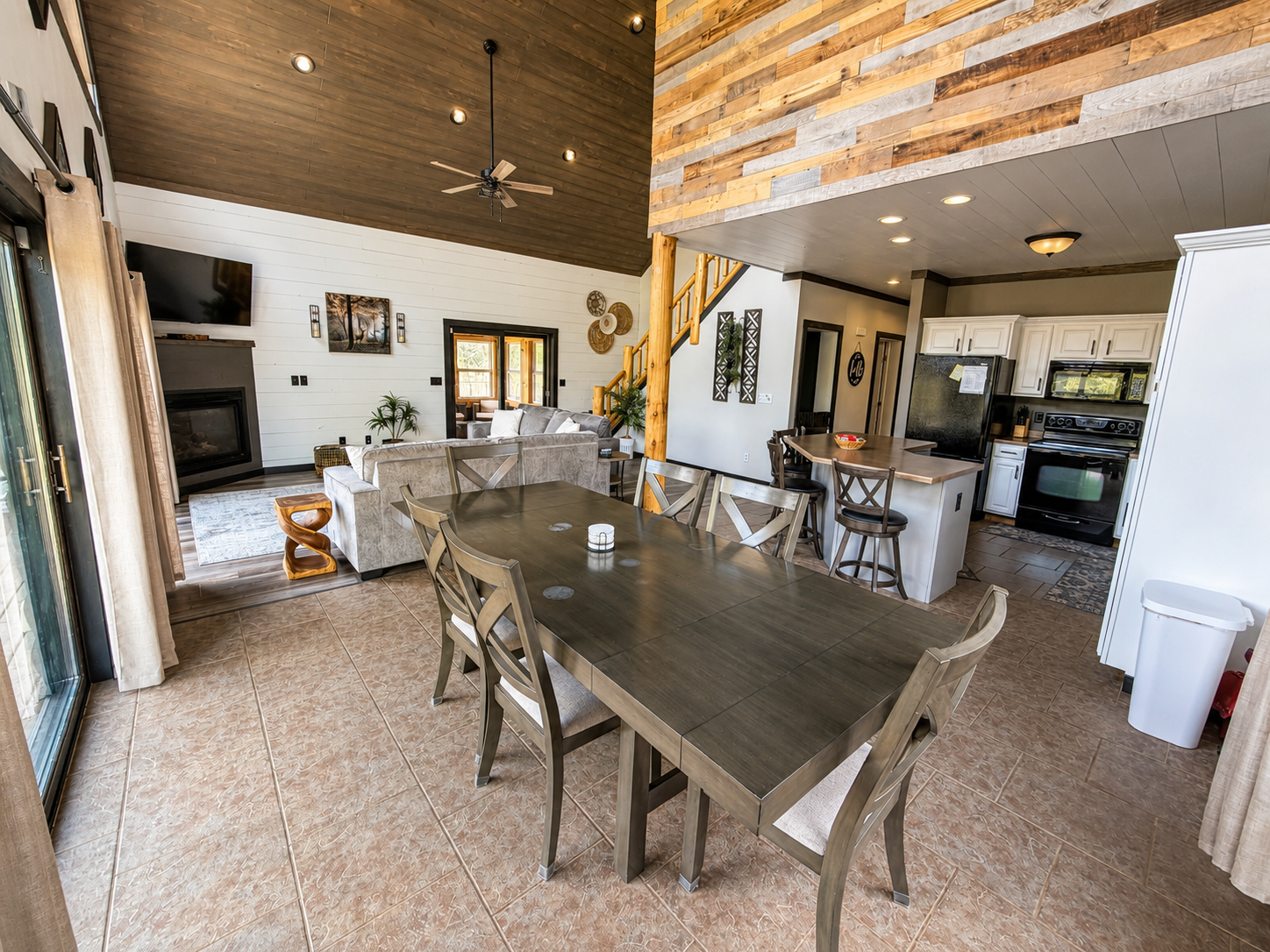 Large dining table sits at the heart of the open living space, making group meals and game nights easy for everyone. The island adds extra seating for large groups.

