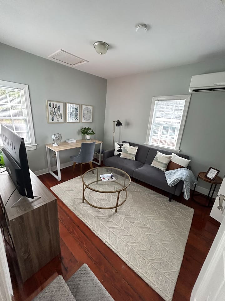 Second floor family room with tv and dedicated work space.