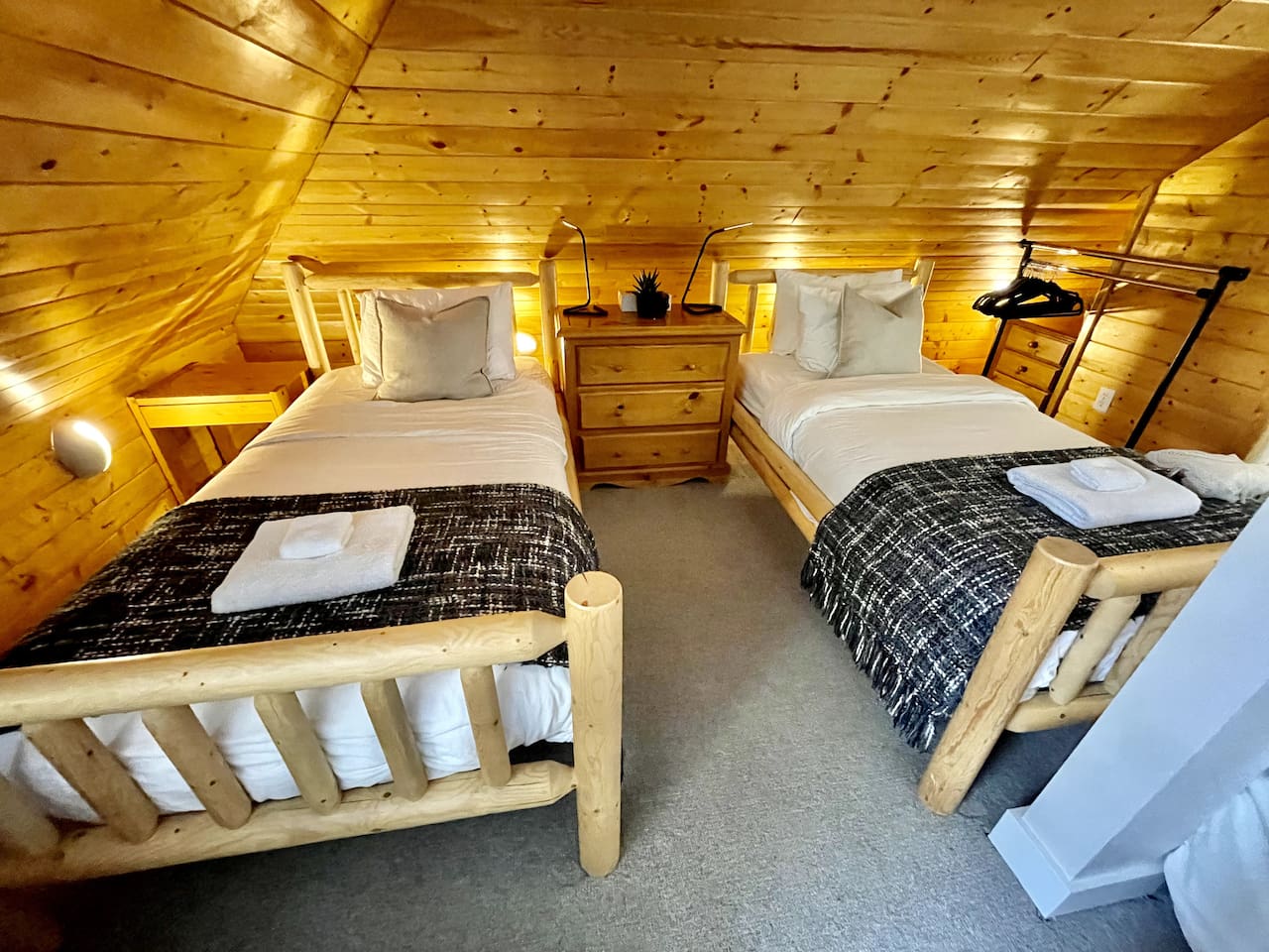 Top floor bedroom has a queen and two twin beds, ensuite bathroom w/ shower, TV lounge area and overlooks the Blackcomb Gondola base and mountain. 