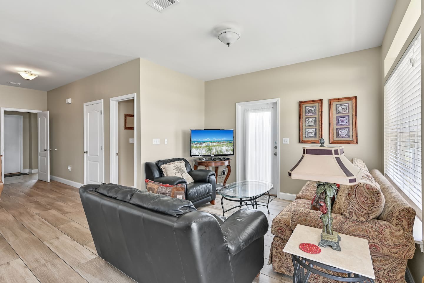 Living Room #1 (First Floor) – Sleeper sofa, loveseat, accent chairs & large TV