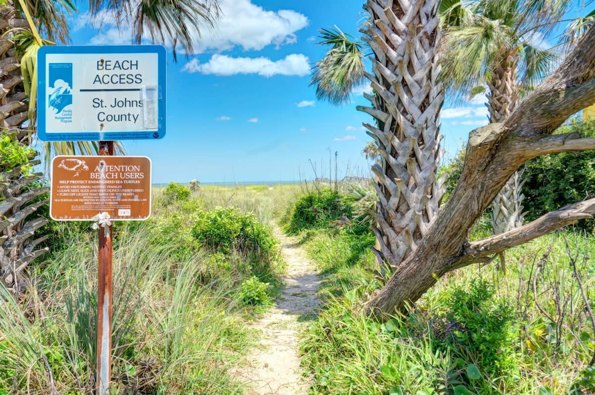 Sixty seconds from the door, the county beach access opens between the sea oats. Sandy feet, a towel over one shoulder, and the Atlantic waiting at the end of the path. You will do this walk twice a day.