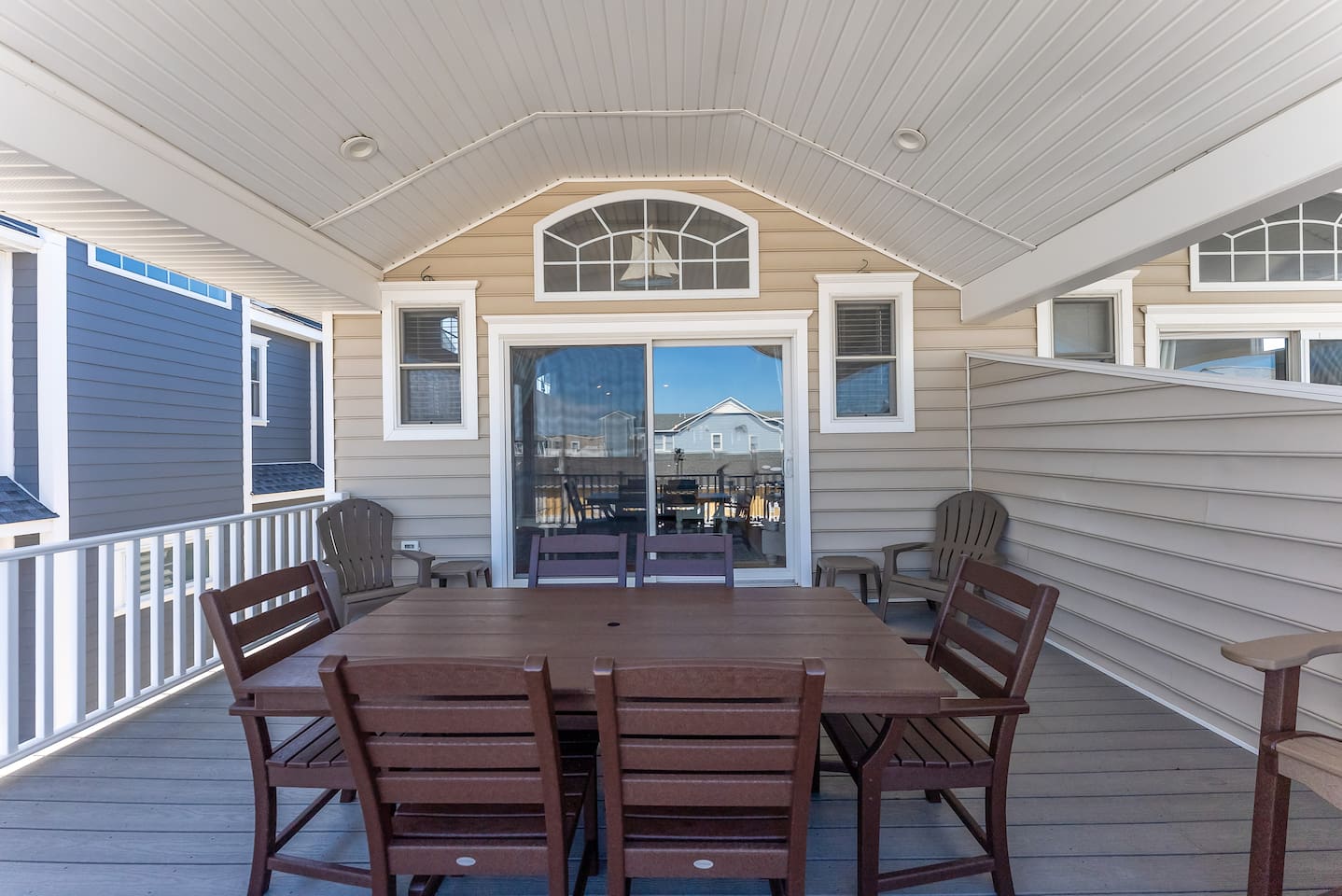 Private covered deck for dining and entertaining off the main living room on the top floor with spectacular ocean views. 
