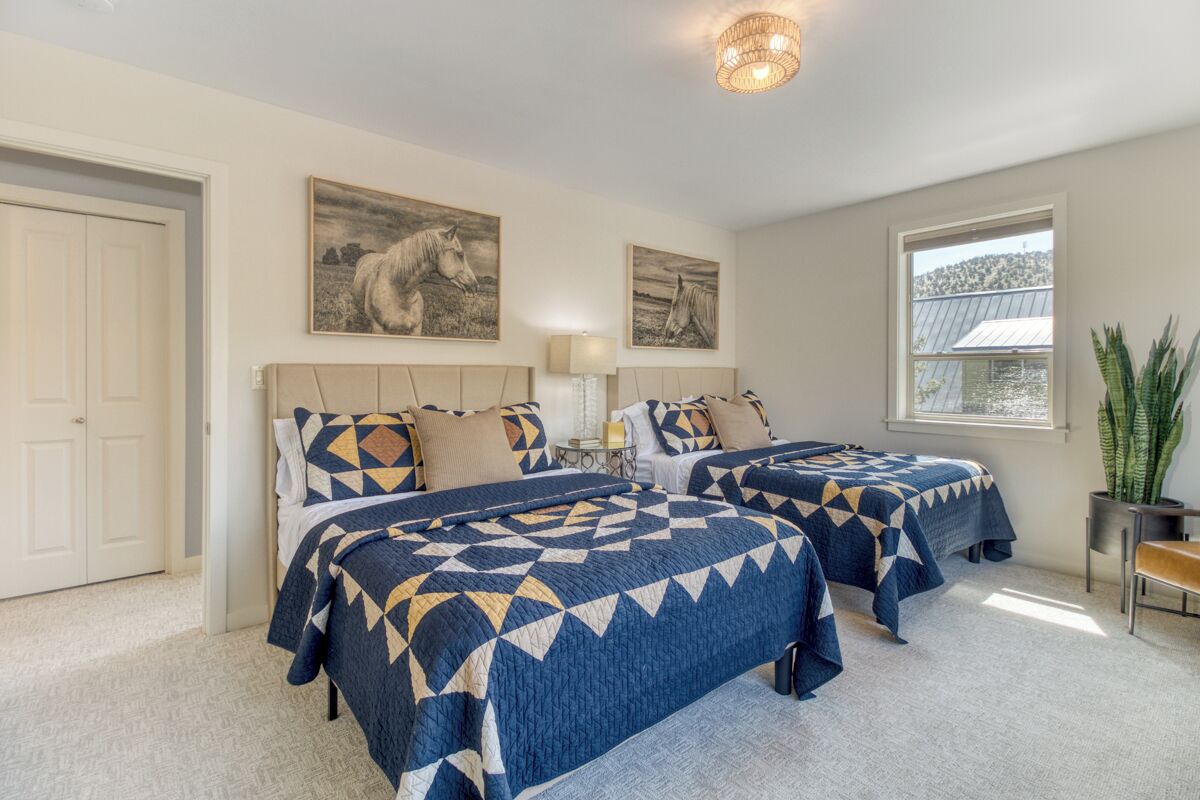 Double beds with cozy bedding and curated art for a luxury resort experience