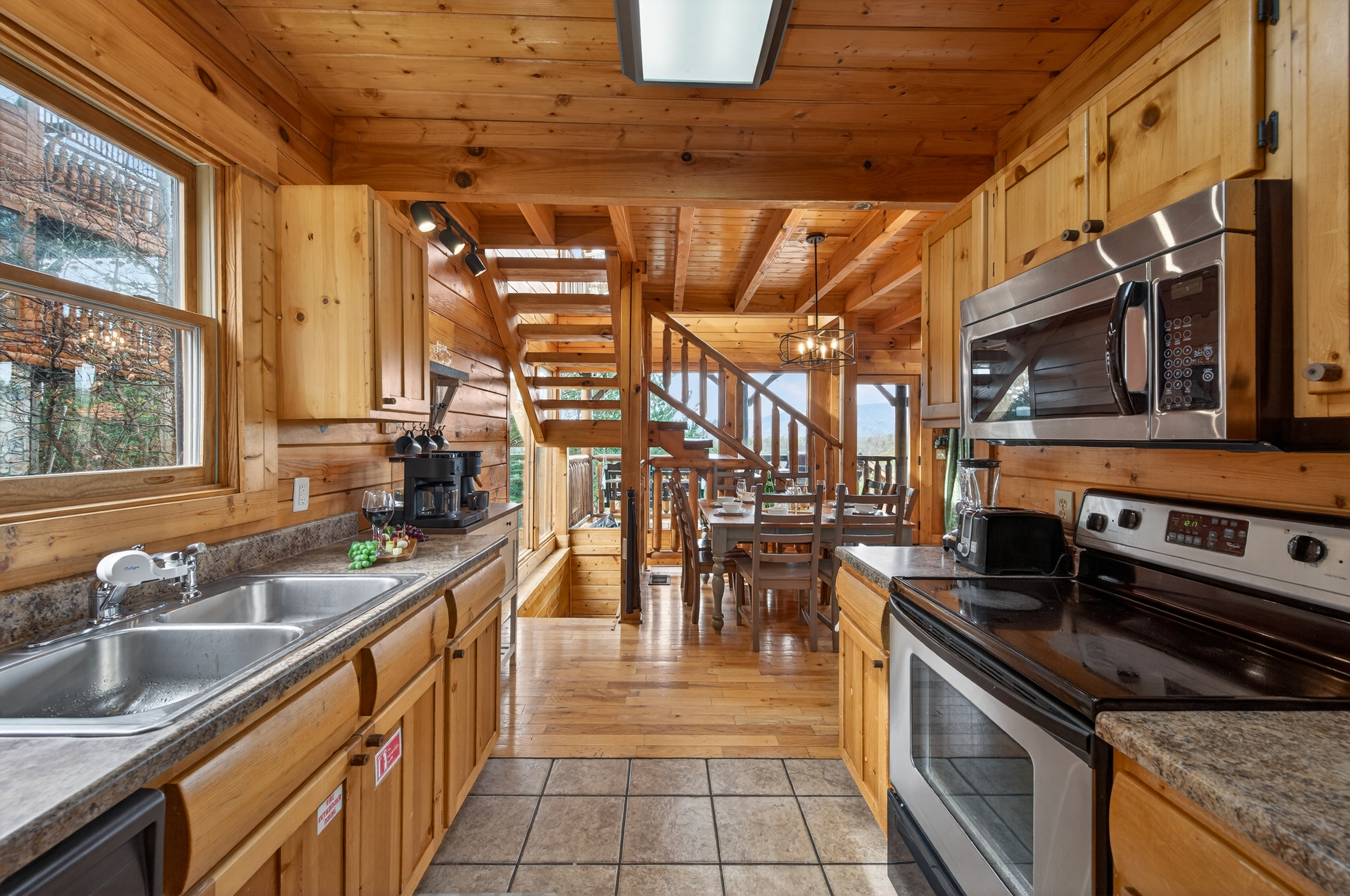 Fully equipped kitchen with everything you need to cook for the whole group — opens directly to the dining area and main level deck.