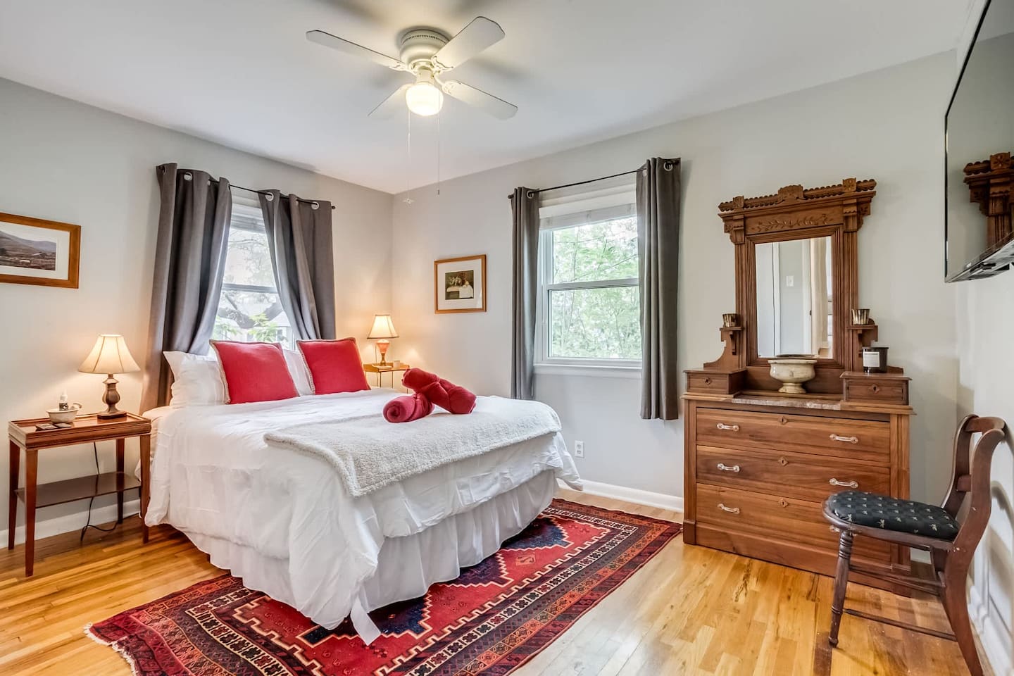 
Step into this cozy, primary bedroom, filled with warm touches and old-fashioned charm. It’s a comfortable, inviting space to slow down and relax after a day of exploring, with a convenient half bath attached.