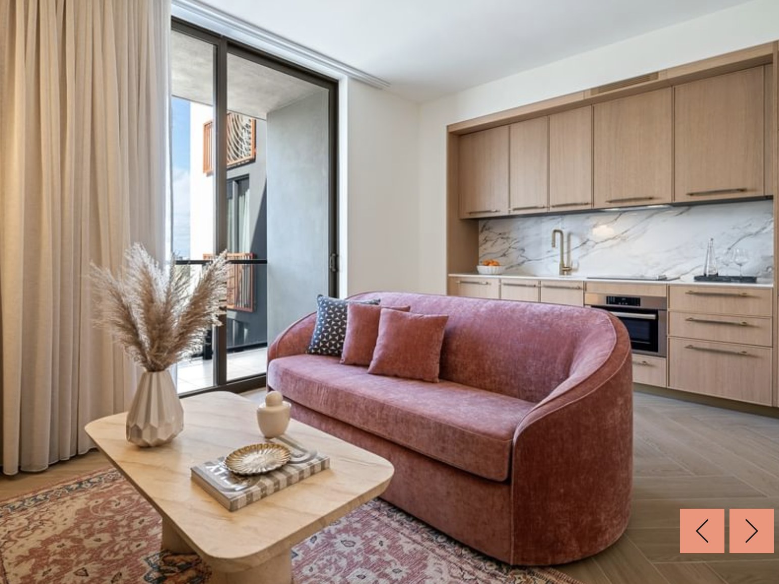 Living room from balcony — natural light and curated decor throughout