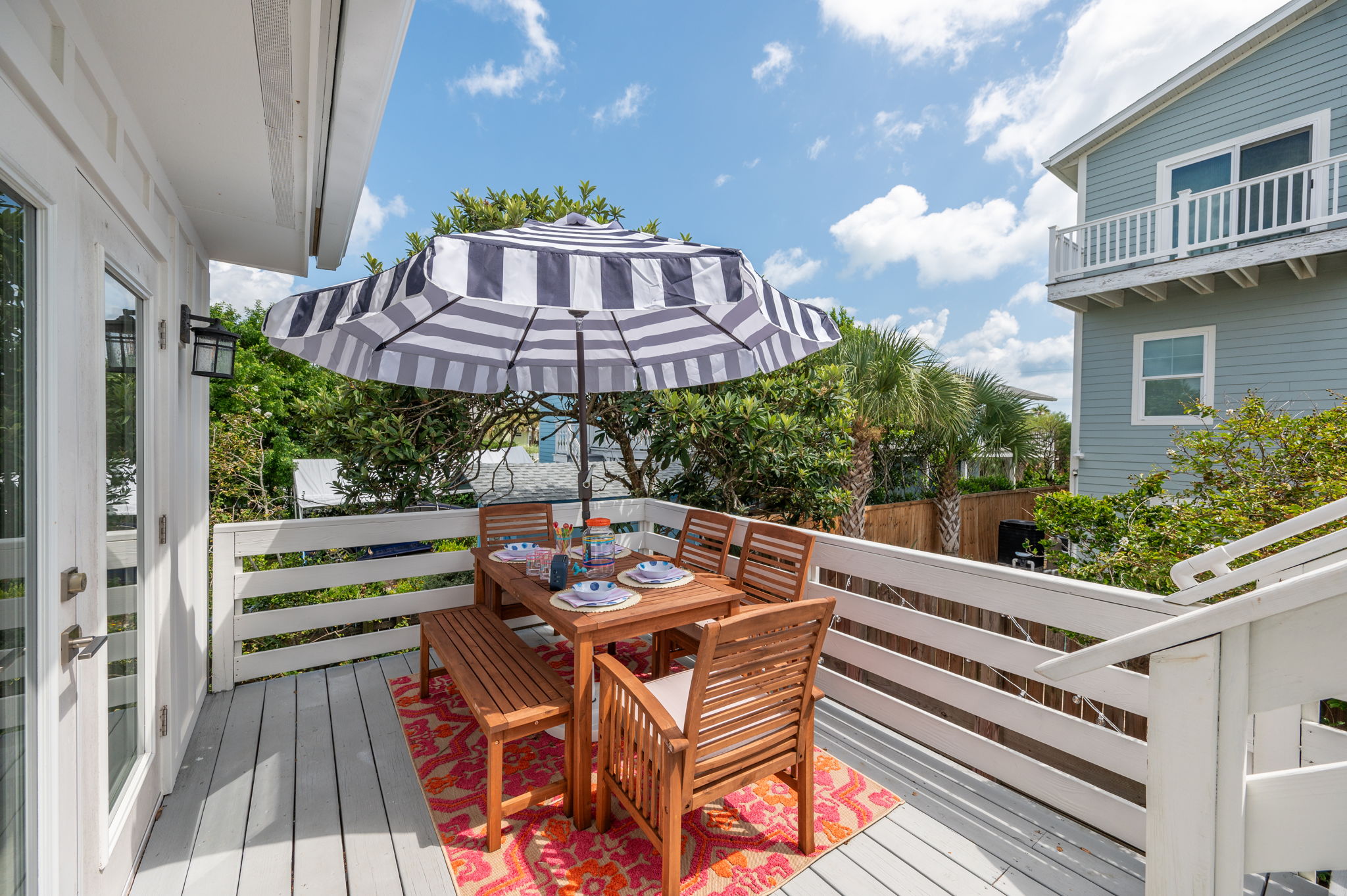 Our spacious outdoor deck, conveniently located off the kitchen, is perfect for dining and lounging. The larger table seats 6-8 (depending on the size of the guests) and comes with an umbrella for sun protection. Plus, there’s a cozy love seat for two and