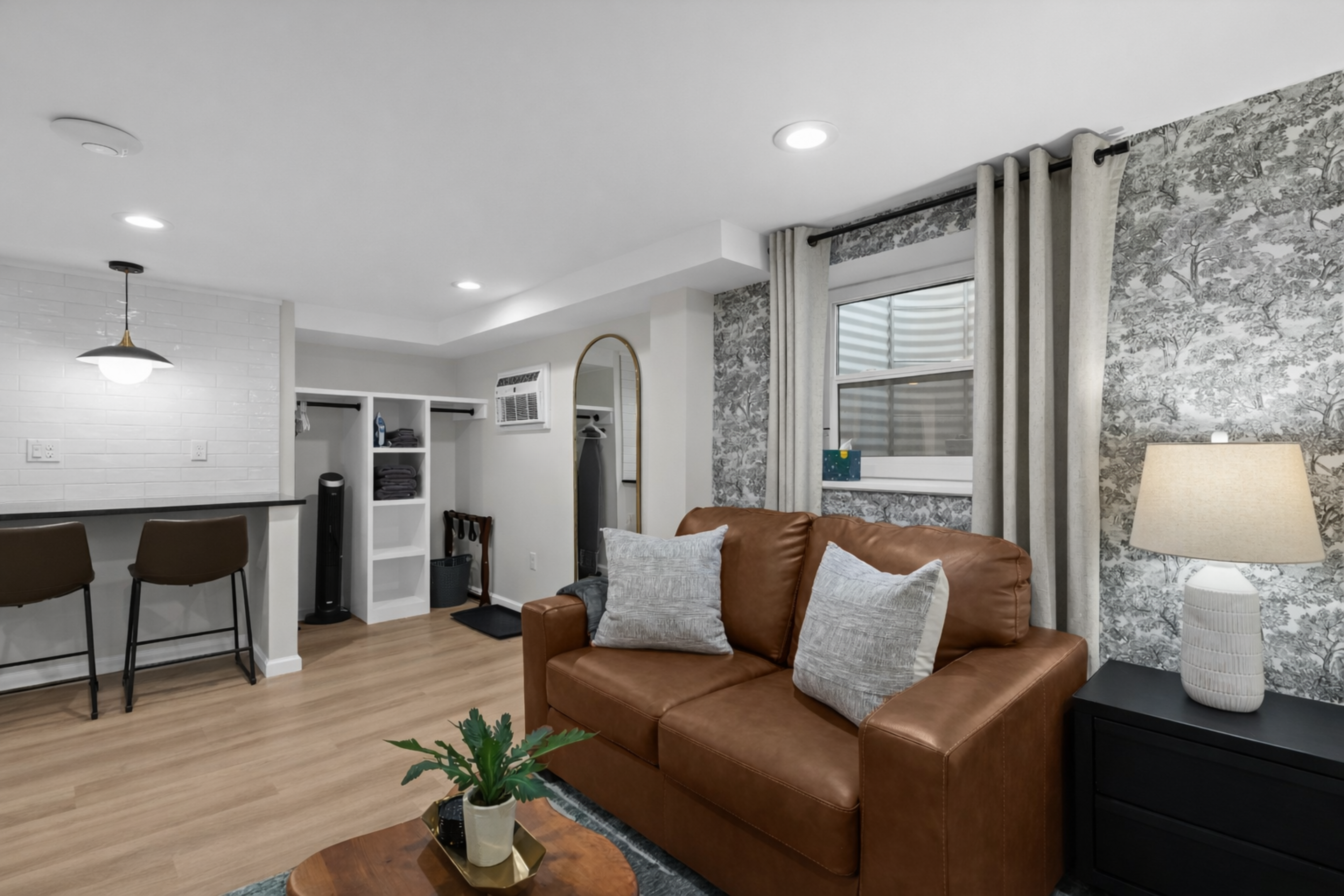 Open, airy layout with a cozy seating area, stylish finishes, and seamless flow to the kitchen and dining space—bright, welcoming, and comfortable.