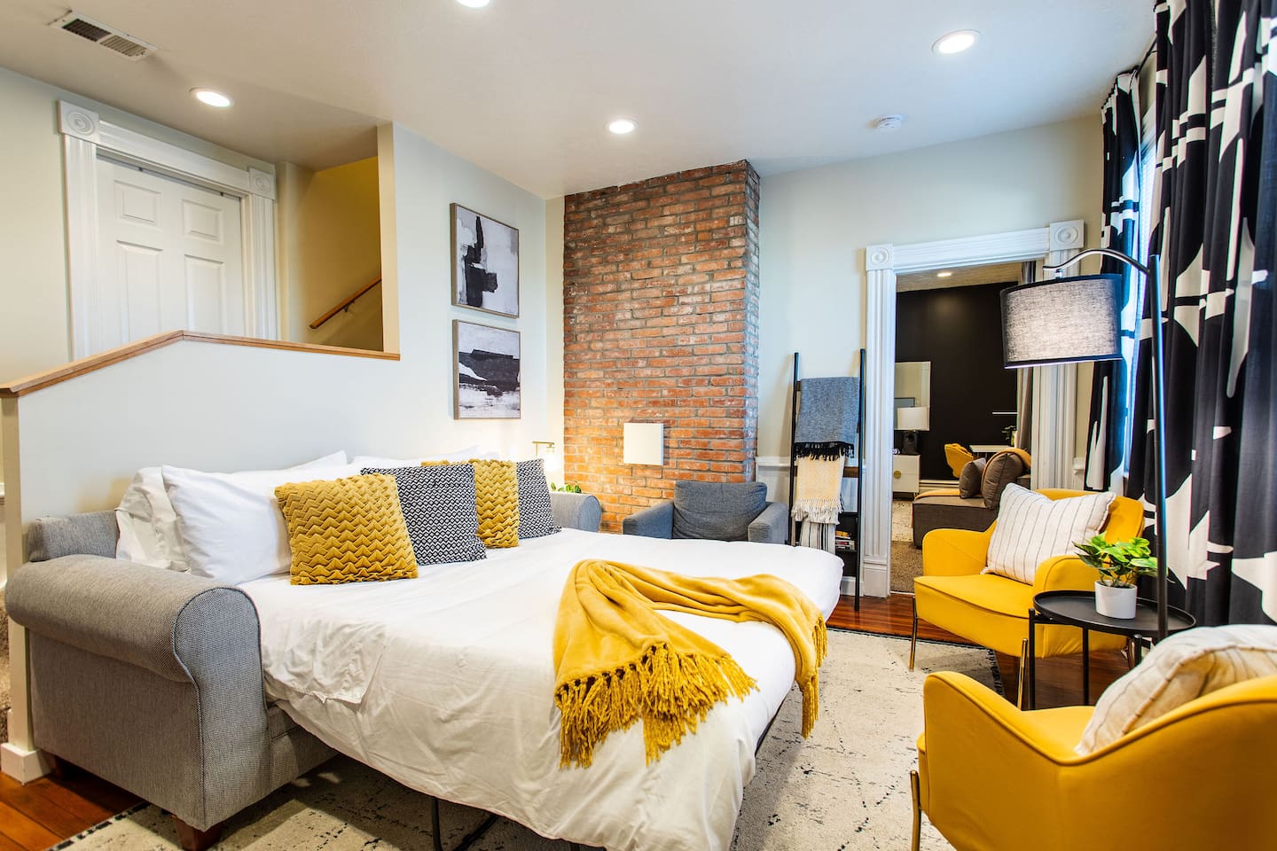 Living area featuring a comfortable couch, a stylish center table, and tasteful wall décor, creating a cozy and aesthetically pleasing space to relax and unwind.