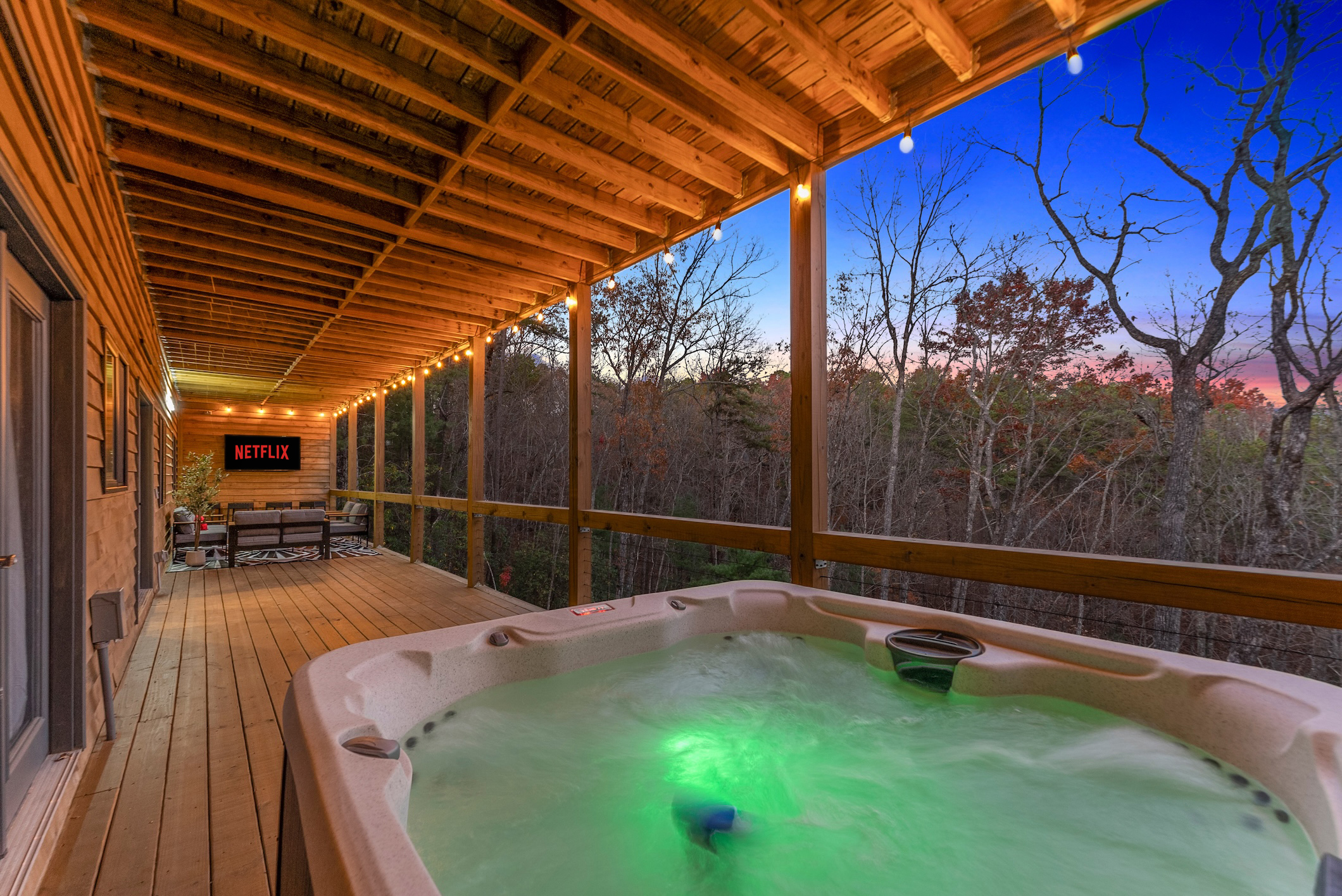 Outdoor hot tub at twilight while enjoying your favorite shows on the outdoor TV—pure relaxation under the stars.