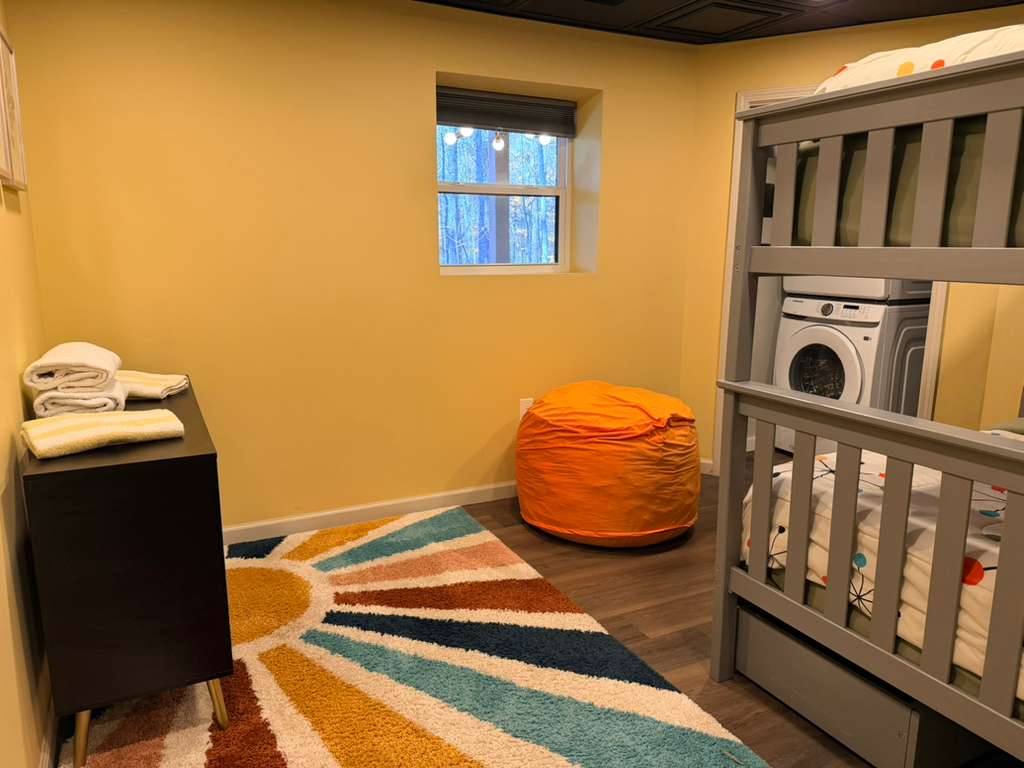 We love the bright walls and unique design. The cozy beanbag and large window add to the playful, comfortable atmosphere.