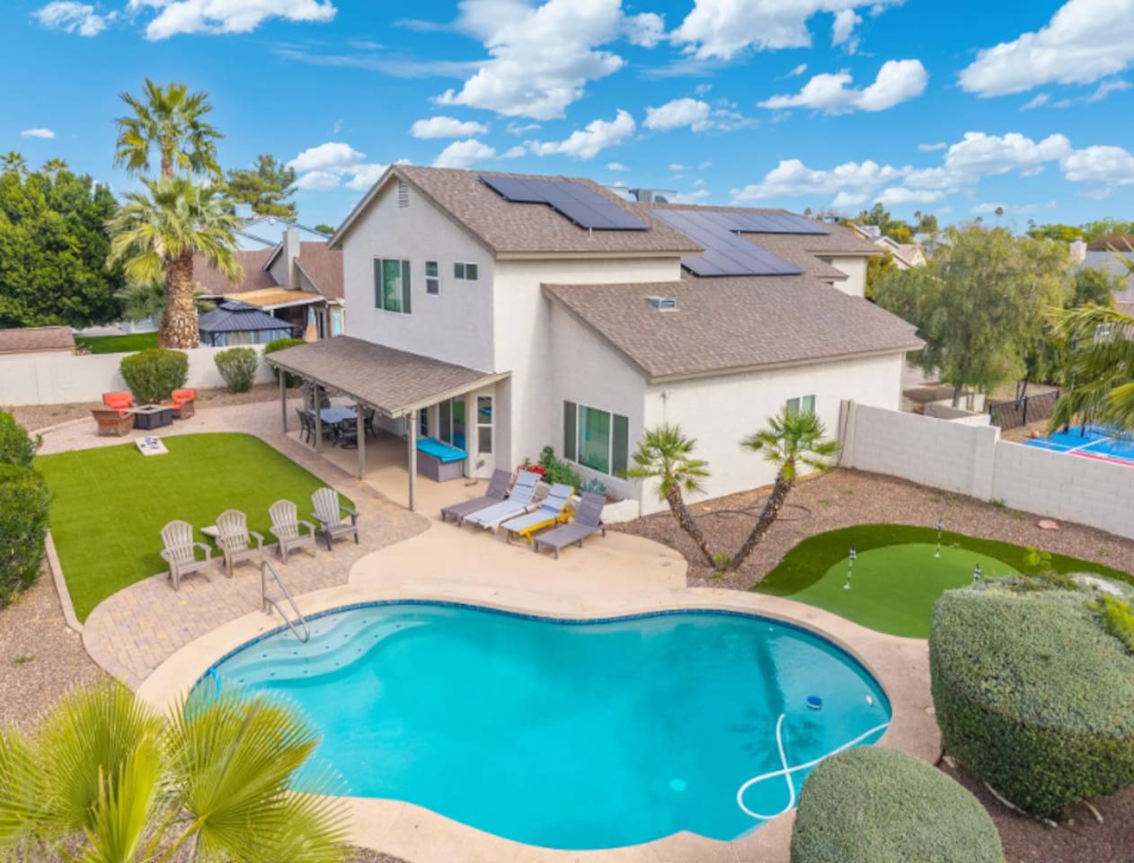 Stunning desert home with resort-style pool, solar panels, and manicured grounds perfect for groups.