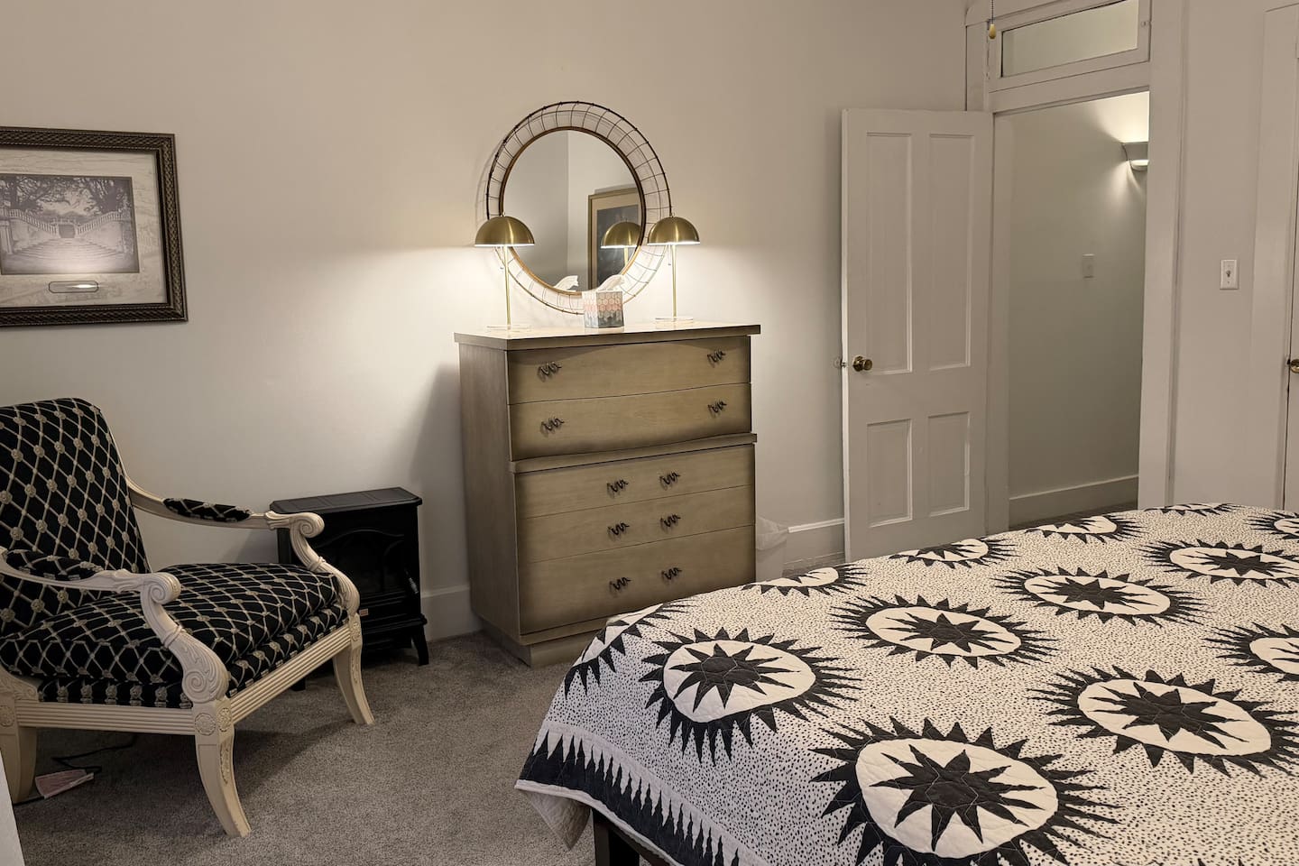 
Cozy electric fireplace, vintage dresser with mirror, and a cozy sitting chair — a calm, beautifully layered corner designed for comfort and ease.