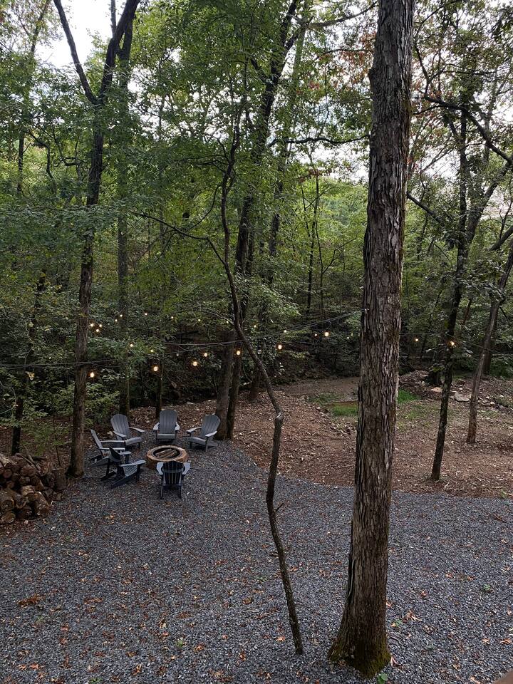 Ample outdoor string lights over the firepit area.