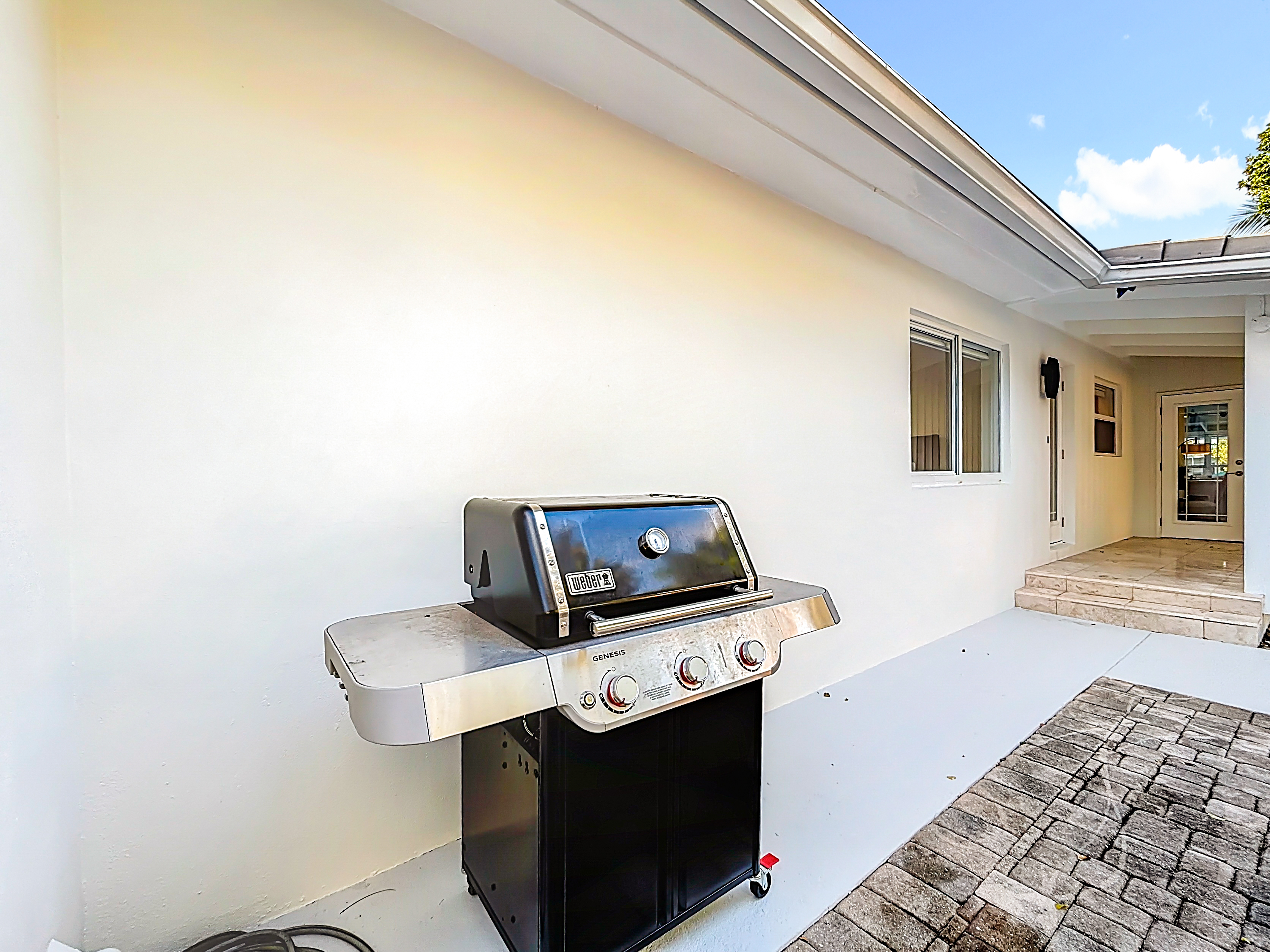 New Weber gas grill with 2 propane tanks- Ready to grill just outside the kitchen. 