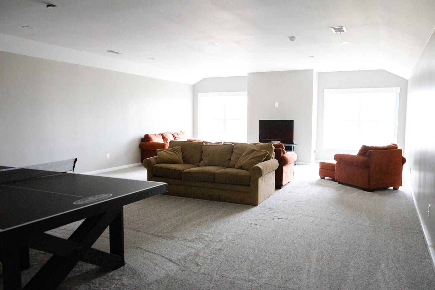 Photos don't capture just how large this additional 1200 sq. ft. of bonus area really is. Ping pong, toys for kids, board games, movie room (coming soon), work space on opposite side, and another twin bed. PLENTY of space to hang out here--very cozy.