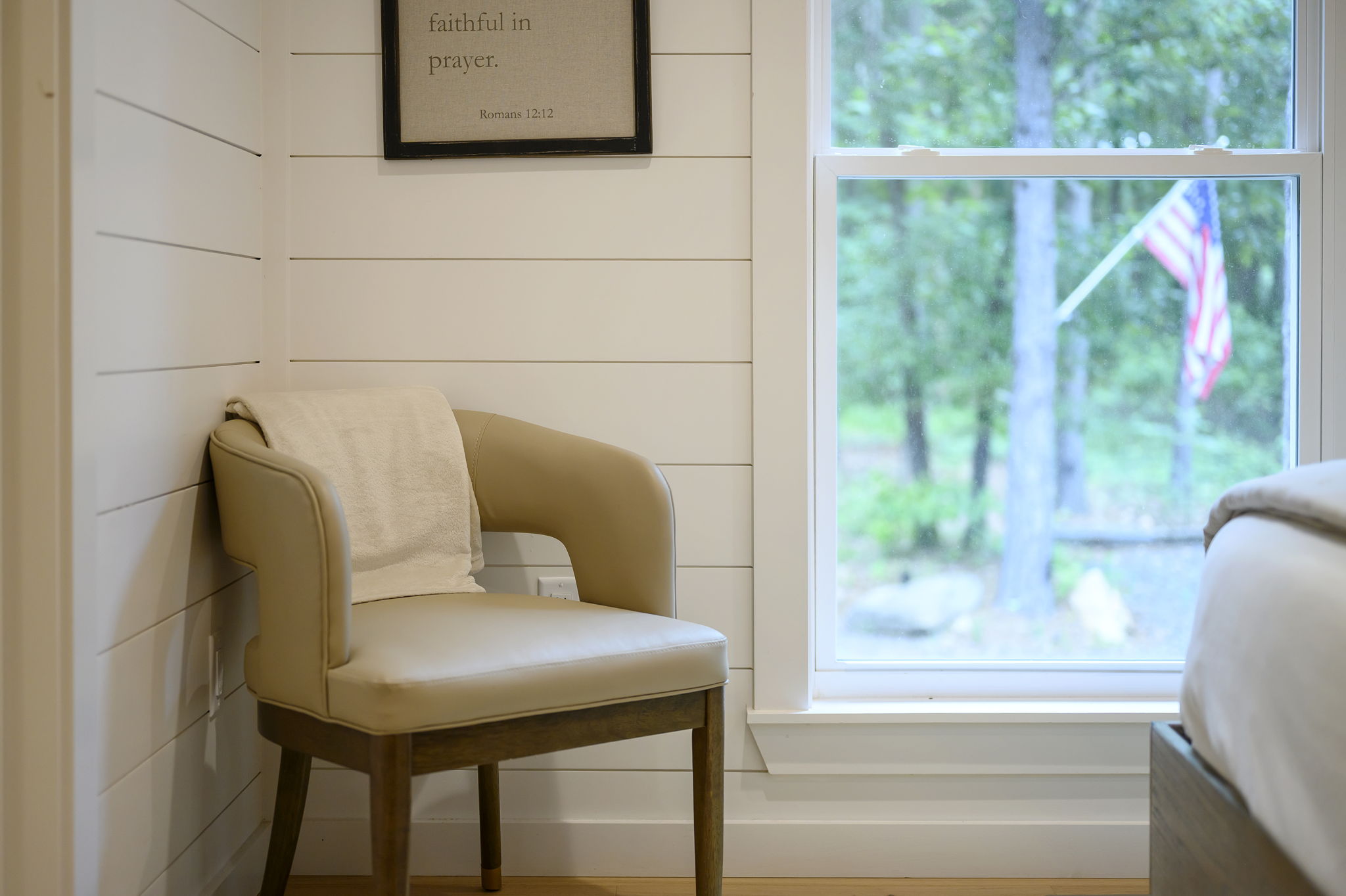 A beautifully appointed queen bedroom featuring luxury design, high-end linens, and peaceful forest views.